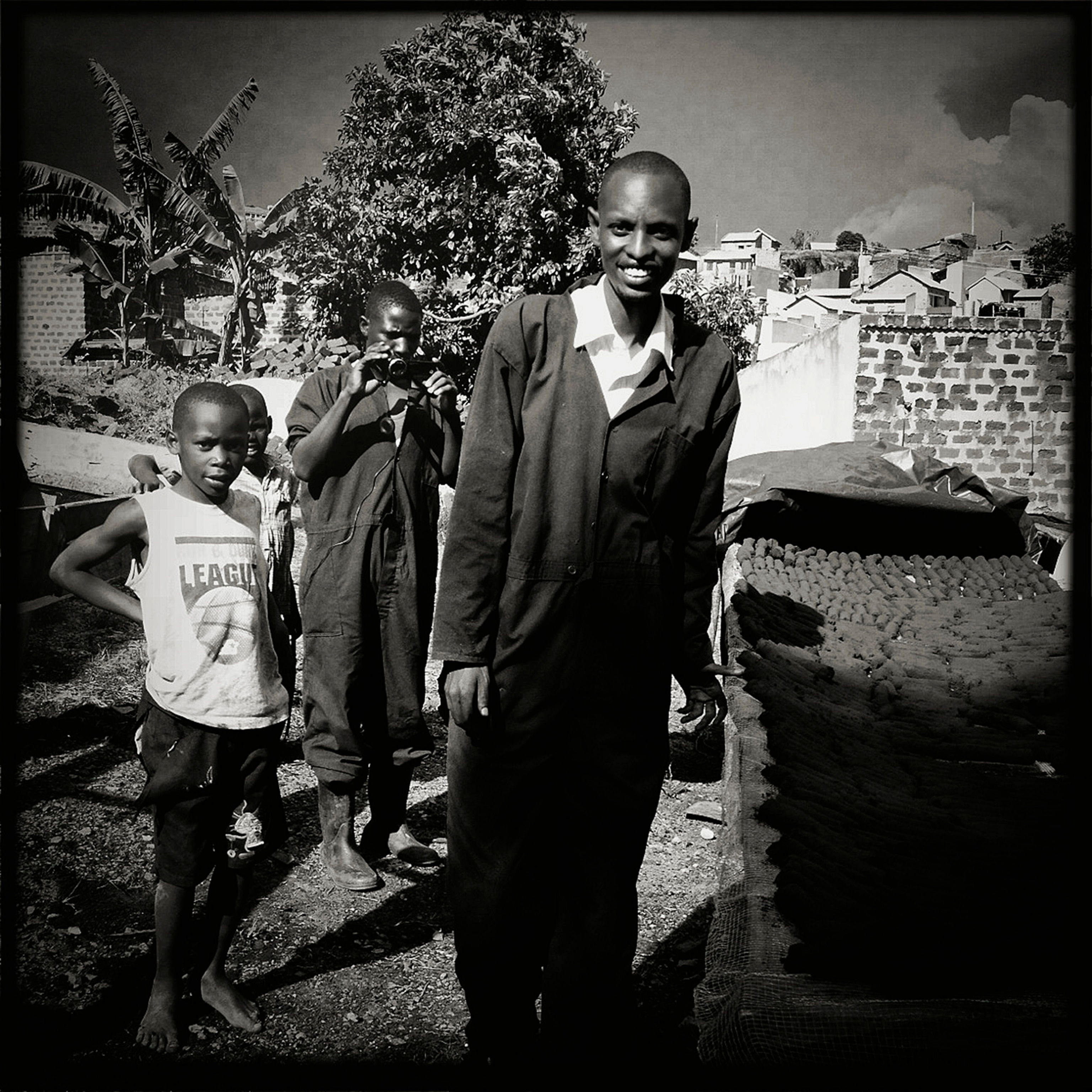 Sanga Moses in the Kasokoso squatter's neighborhood where he has set up one of his businesses called Eco-Fuel Africa Limited. Sanga has a dream to help sell efficient eco-friendly fuel to more than 40 million Africans.
Photographs of 2012 TED FELLOW Sanga Moses. Sanga grew up in the small village of his namesake in Southwestern Uganda. He is an entrepreneur who has started a variety of companies in his country. The latest and most successful of his enterprises is Eco-Fuel Africa Limited, an eco-fuel company. He turns bio-waste into cooking fuel for poor Ugandans. Deforestation is a massive problem for the country and he dreams of having 40 million Africans using his more eco-friendly fuel.