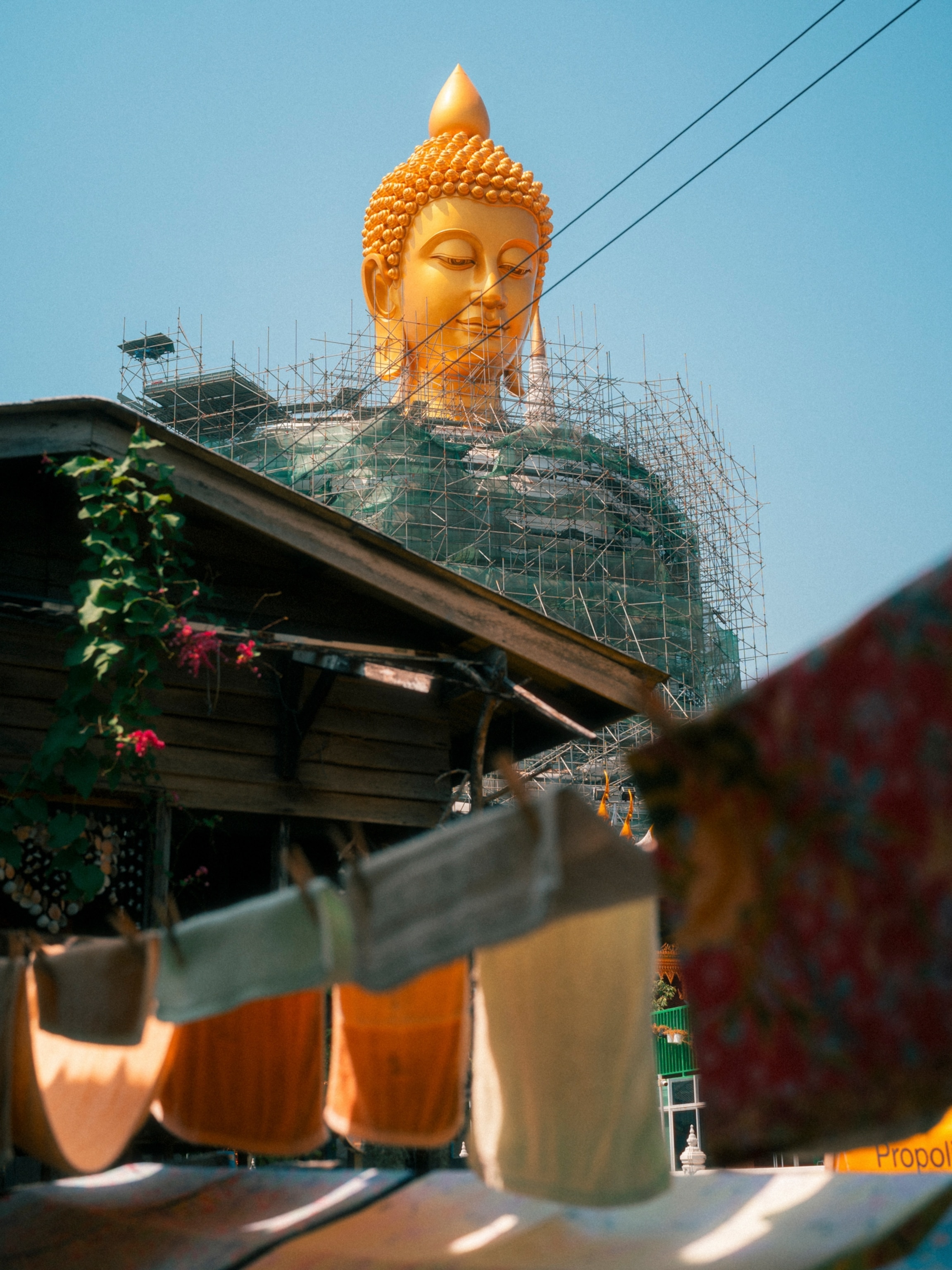 Scaffolding encompassing a large gold Buddha statue.
