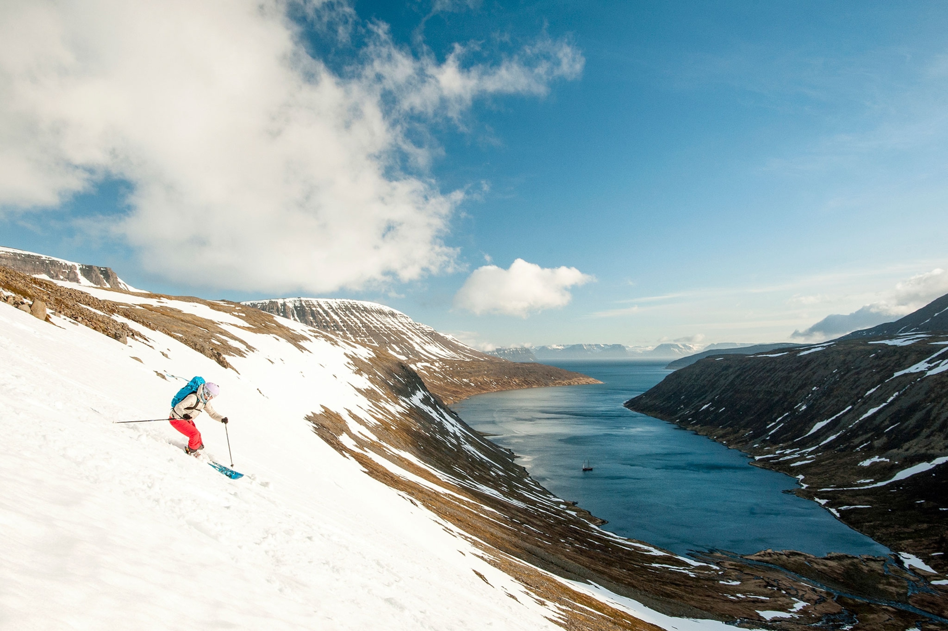 skier skiing down to a fjord in Iceland