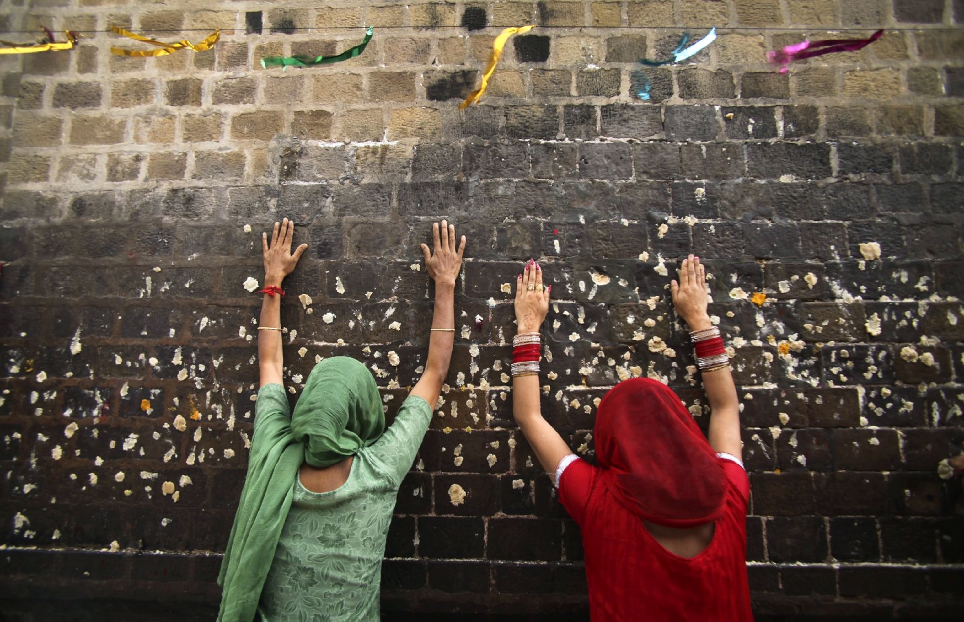 two women praying in India.