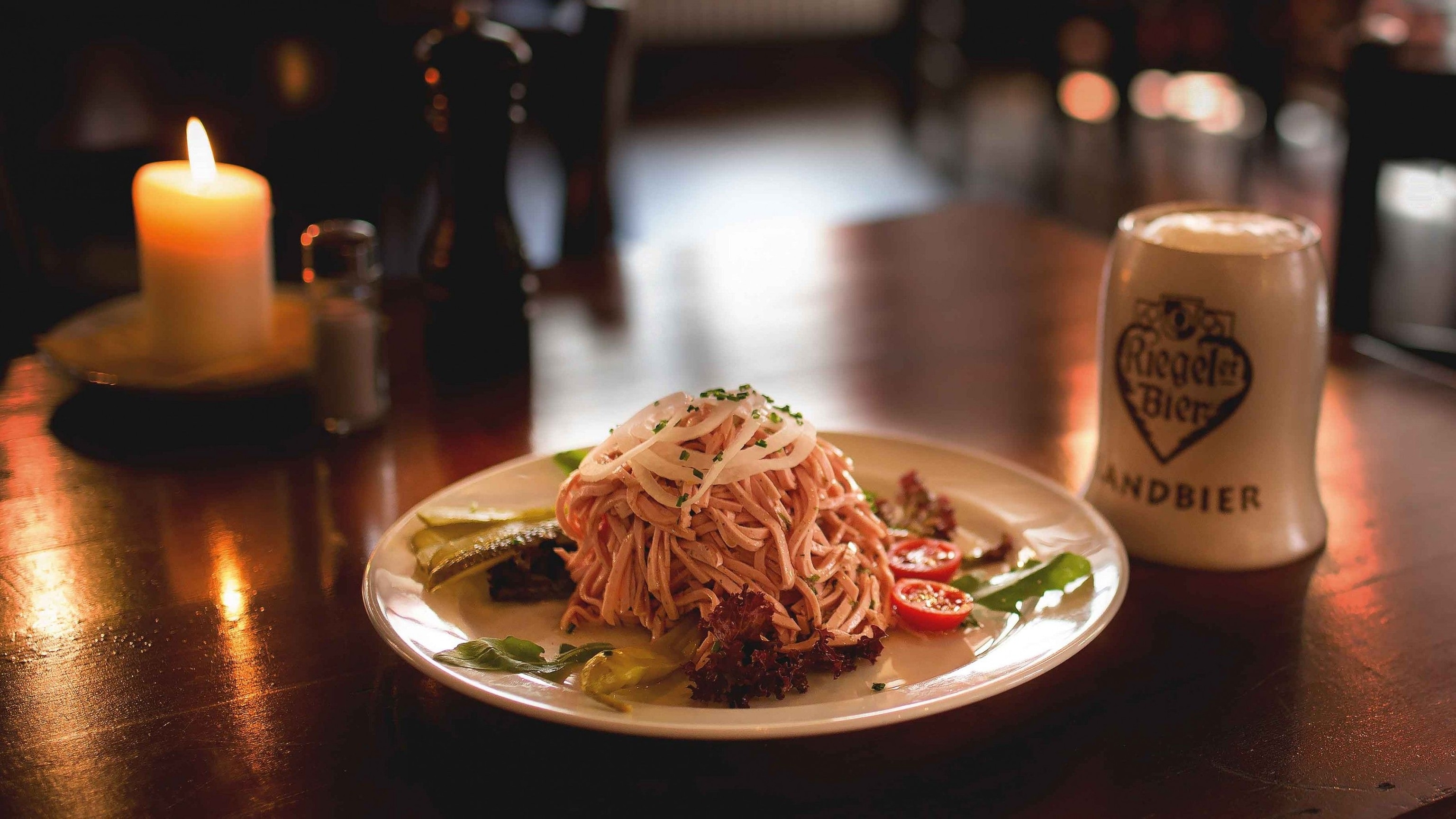 Wurstsalat is a salad made with pink strips of Lyoner sausage dressed with oil and vinegar, served with a soft wheat sourdough.