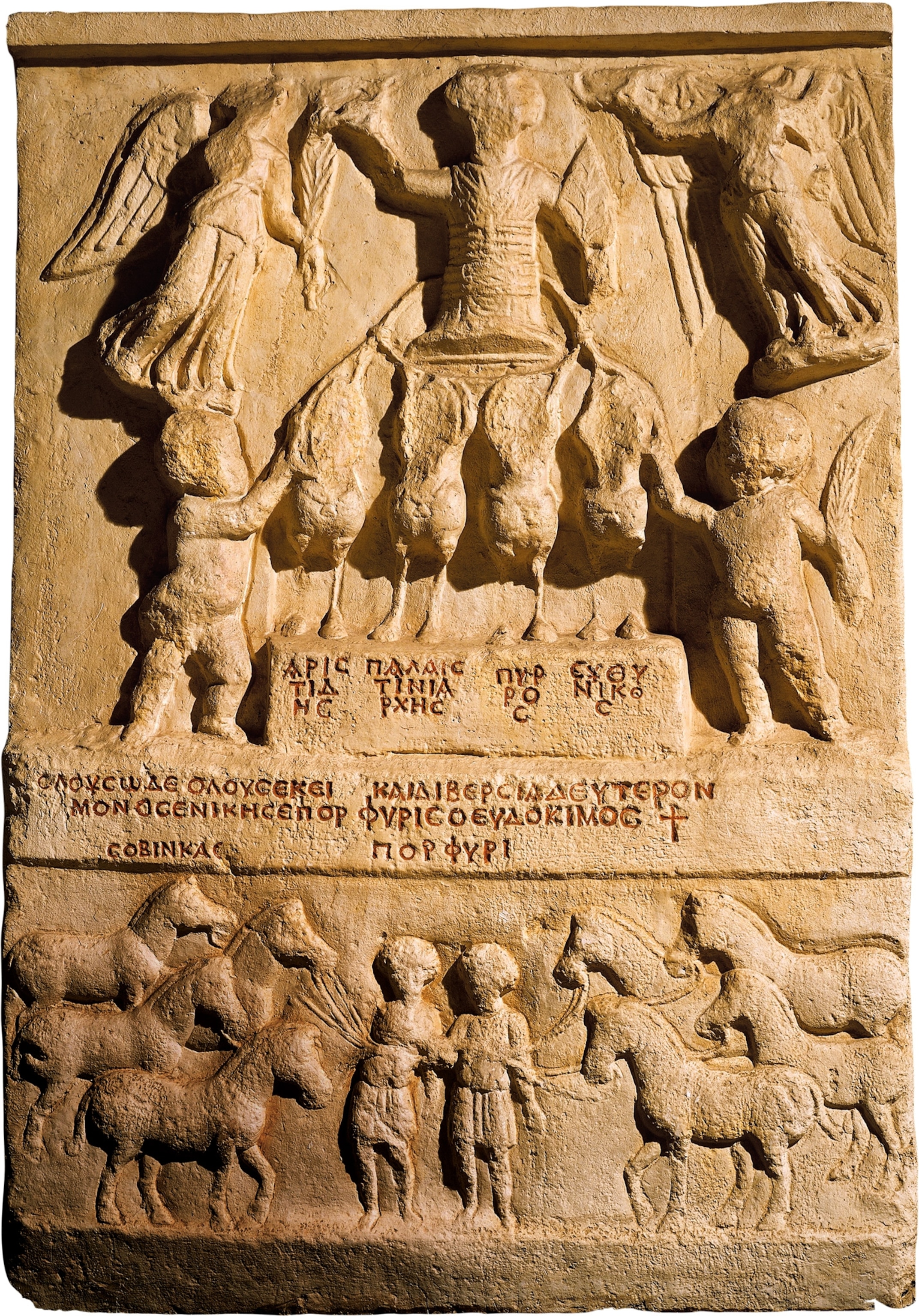 A stone relief of people and horses