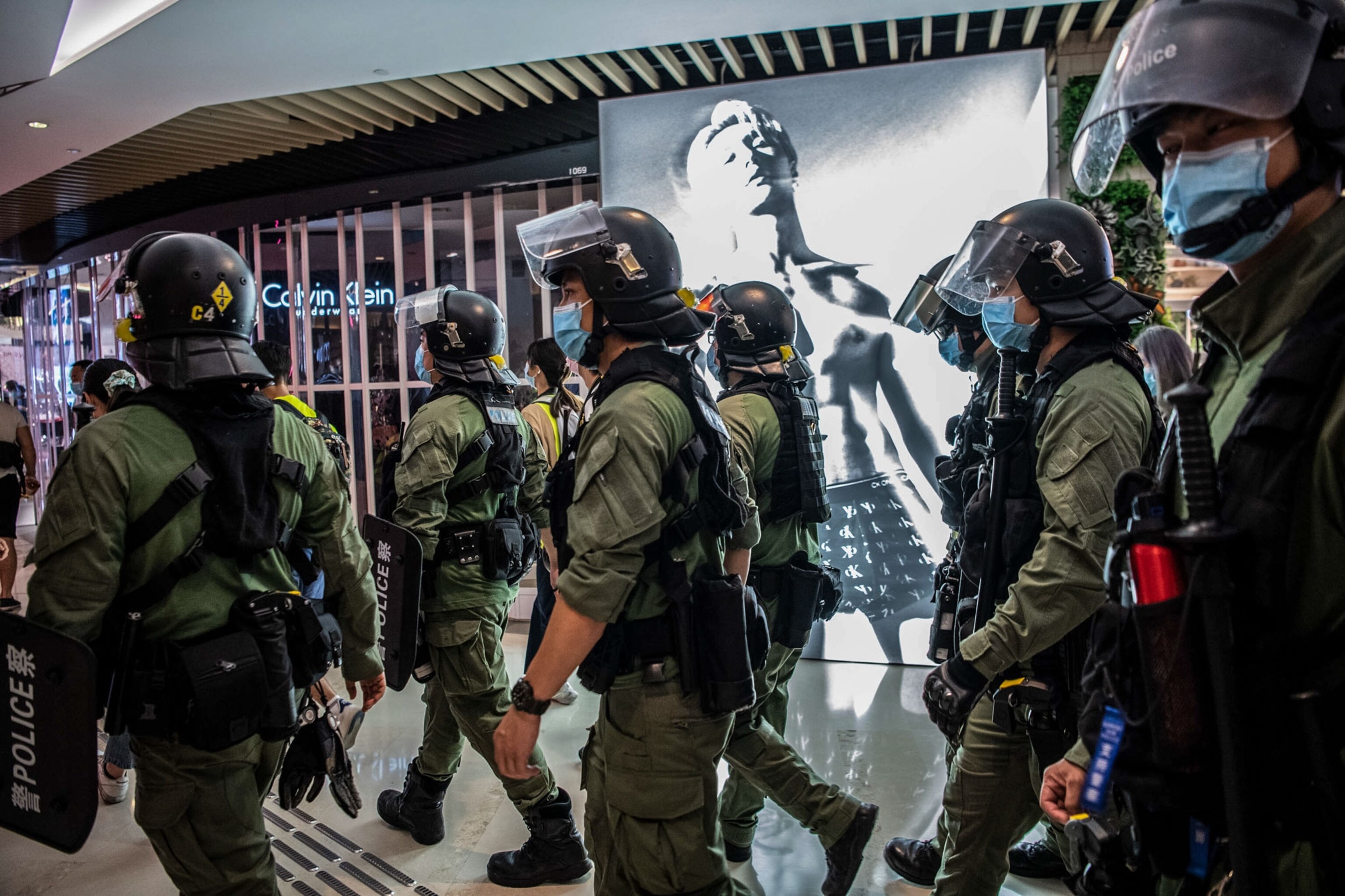 police walking through a mall in Hong Kong