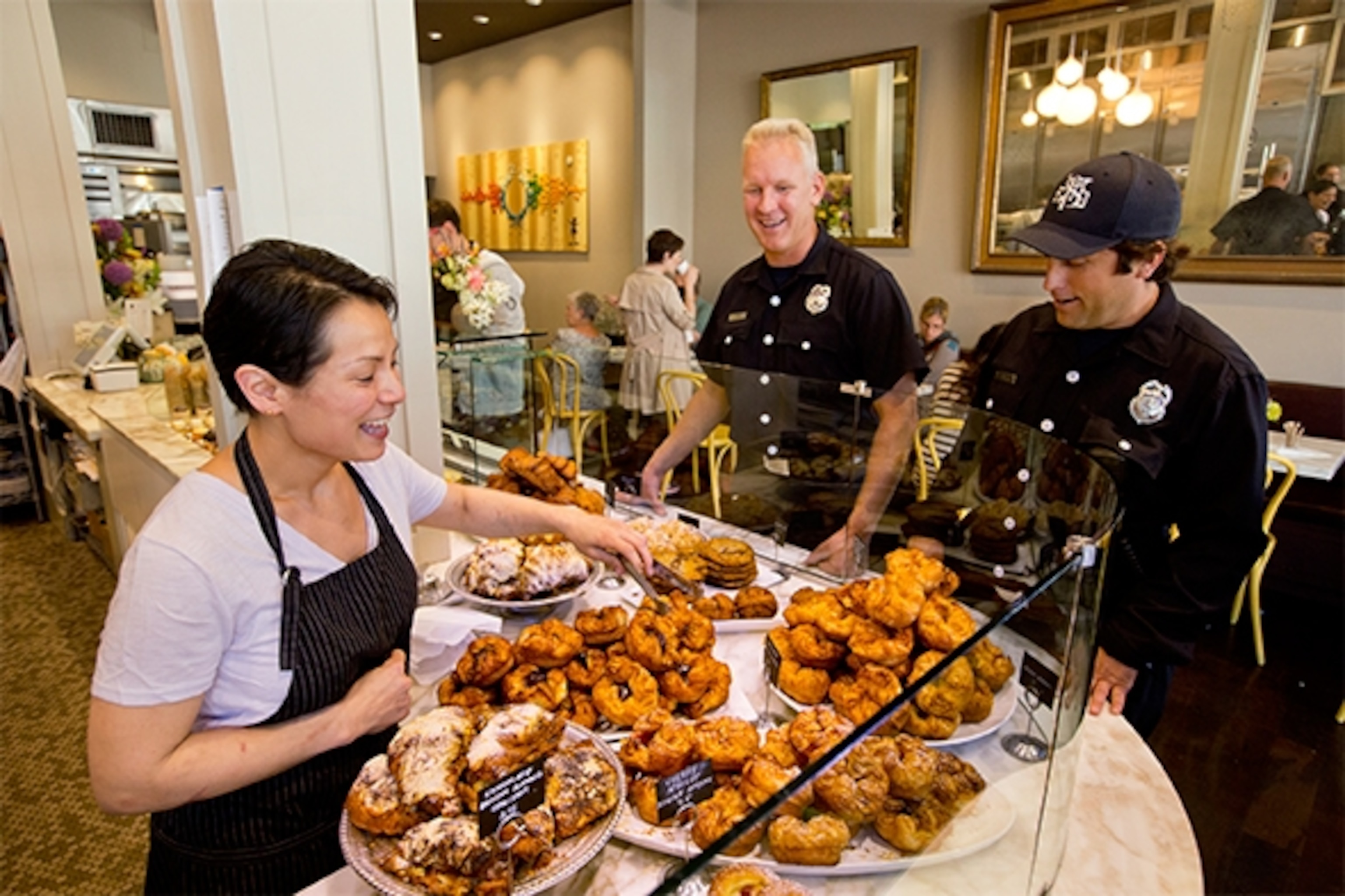 Belinda Leong, owner of San Francisco's hot new b. Patisserie greets firemen who come in regularly for her signature light and flaky pastries. (Photograph by Catherine Karnow)