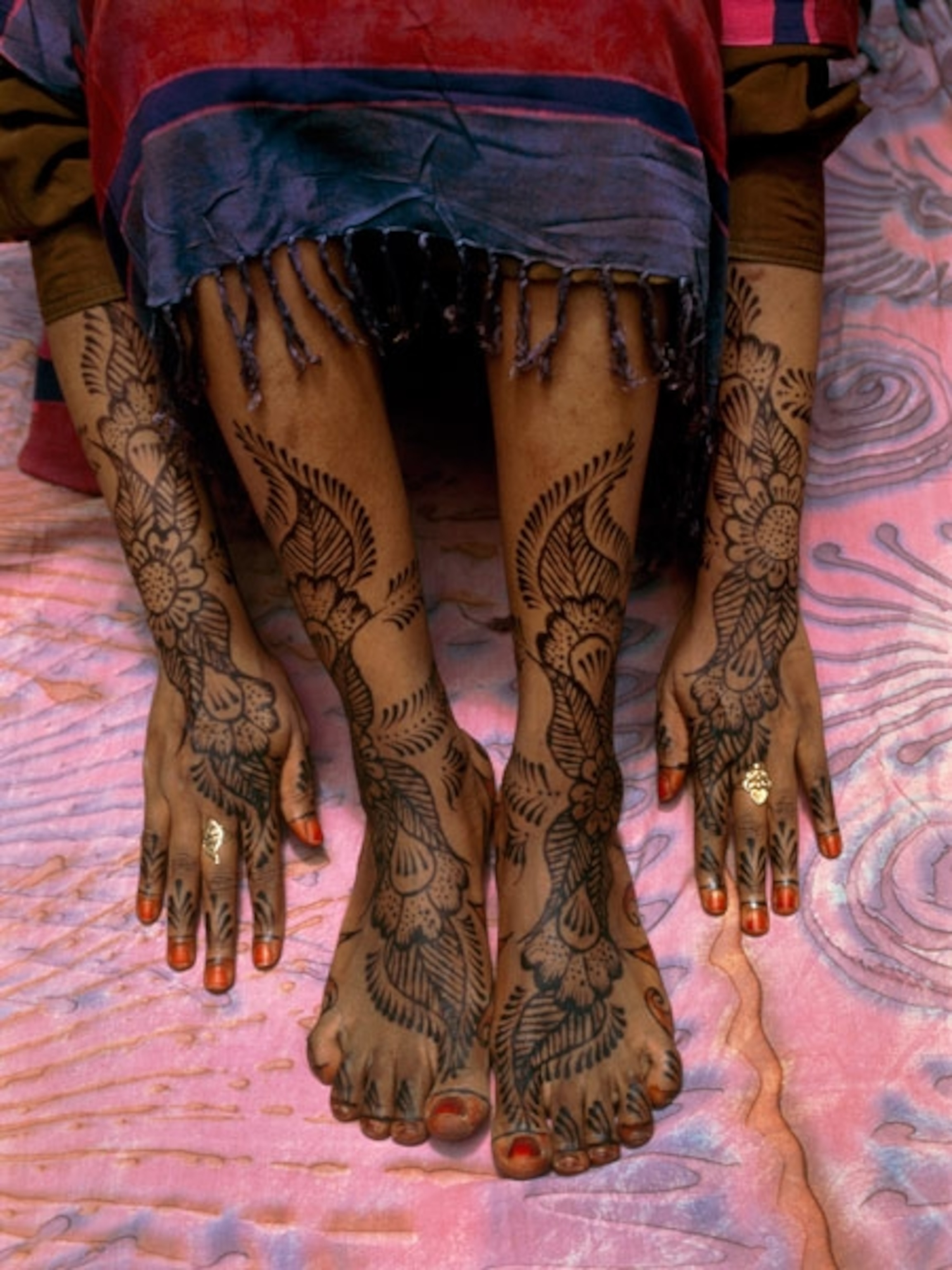 Henna designs on a woman’s feet and arms