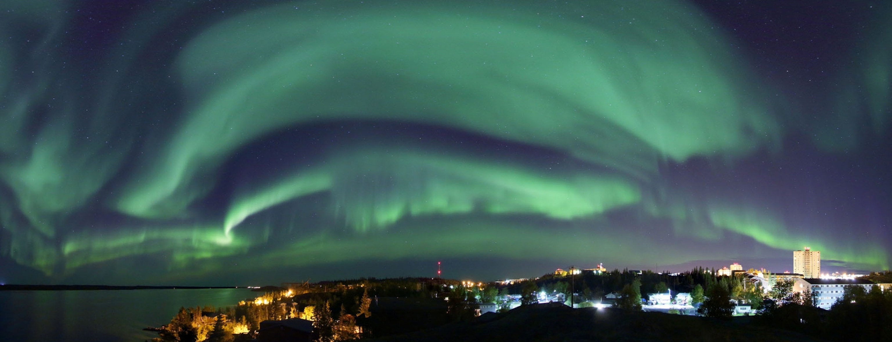 The aurora image is captured over Yellowknife in the Northwestern Territories, Canada. Yellowknife is known as one of the world's best aurora destinations, due to far northern magnetic latitude, and easily accessible.