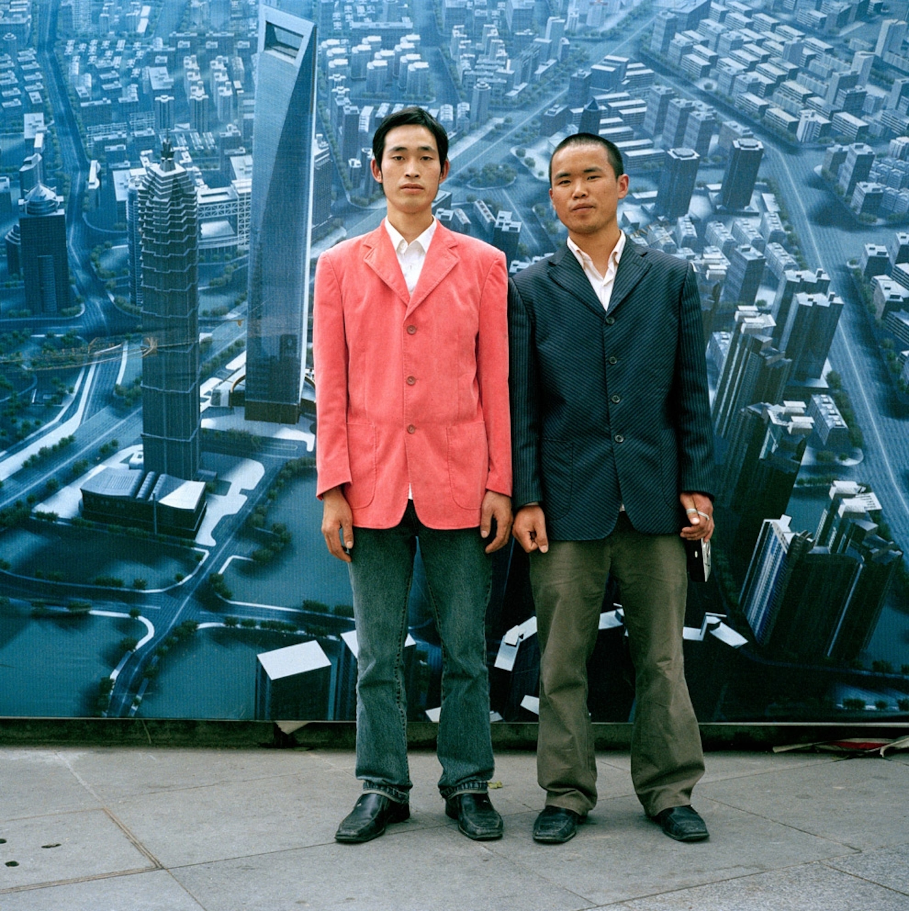 Two men standing in front of a billboard