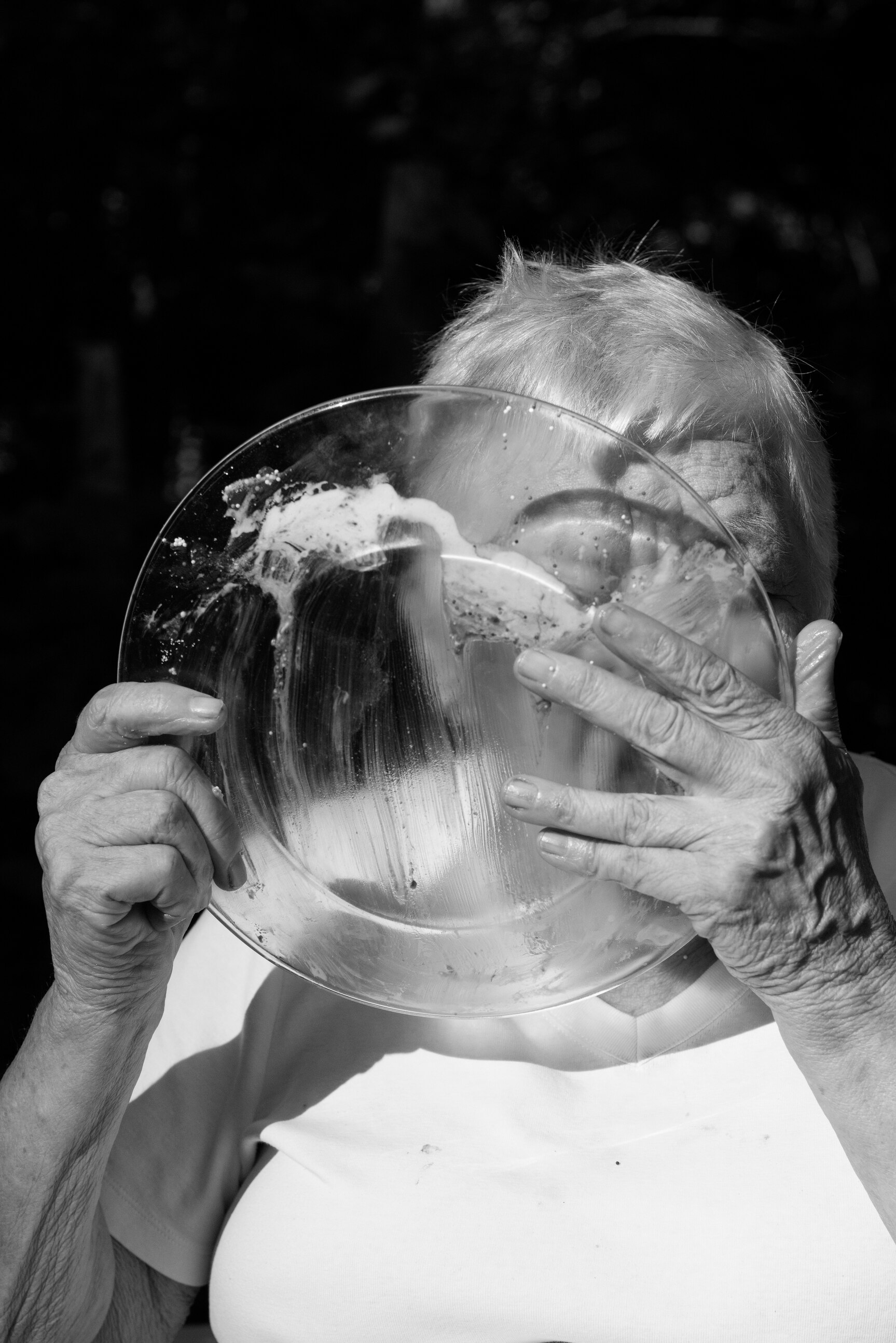 A woman licking her dessert plate