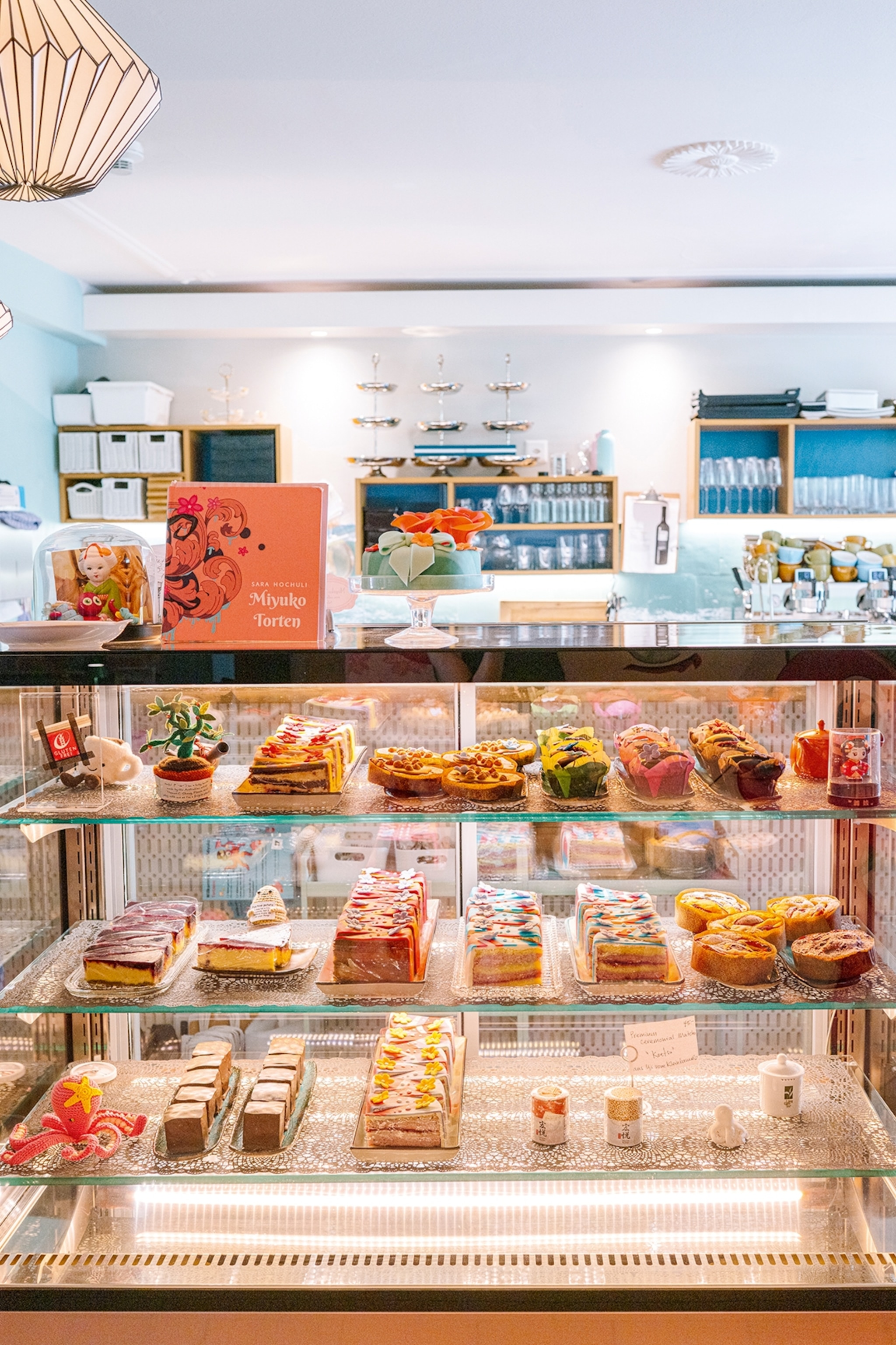 A vibrant and stacked cake display with Japanese memorabilia.