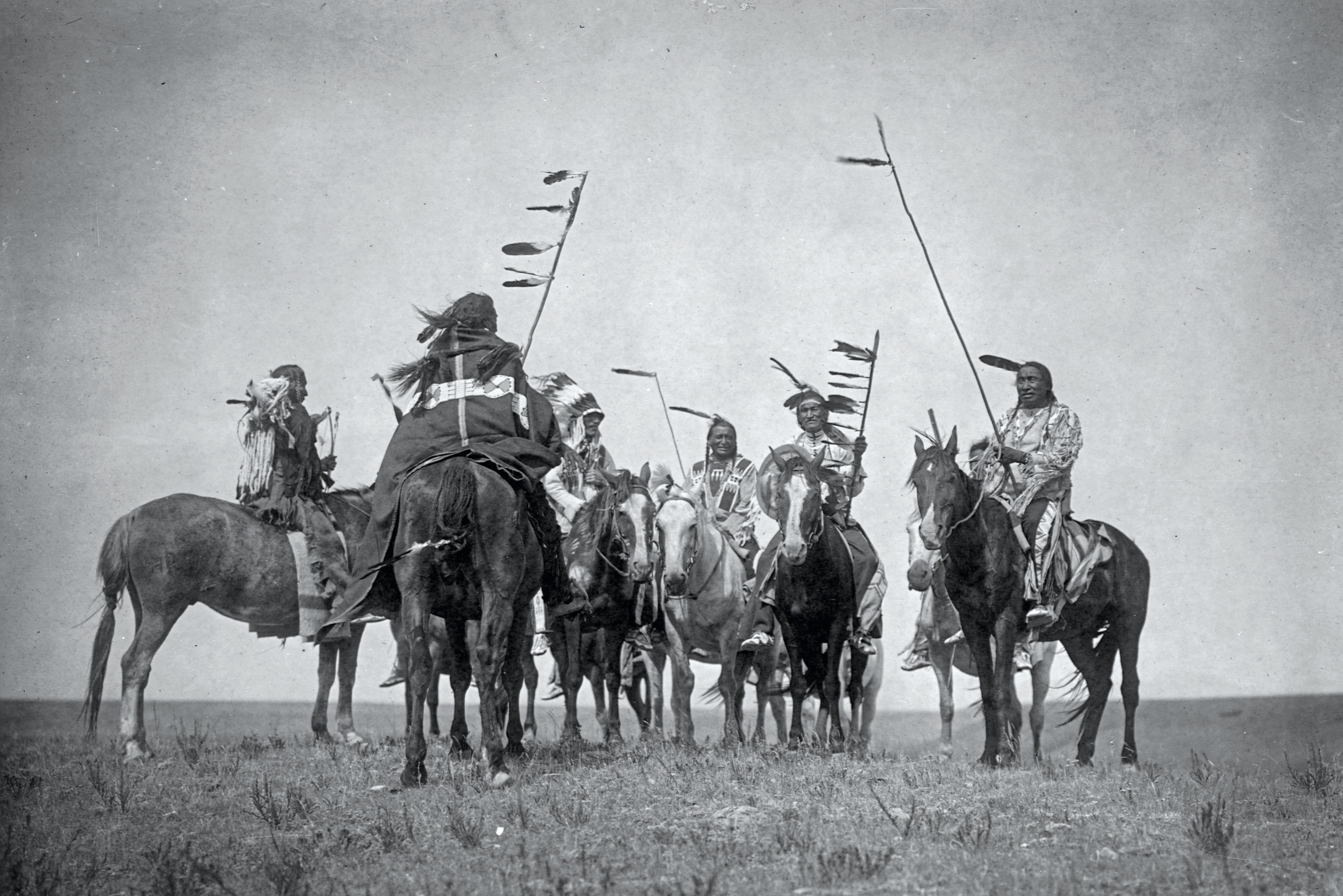 Atsina warriors on horseback are pictured.