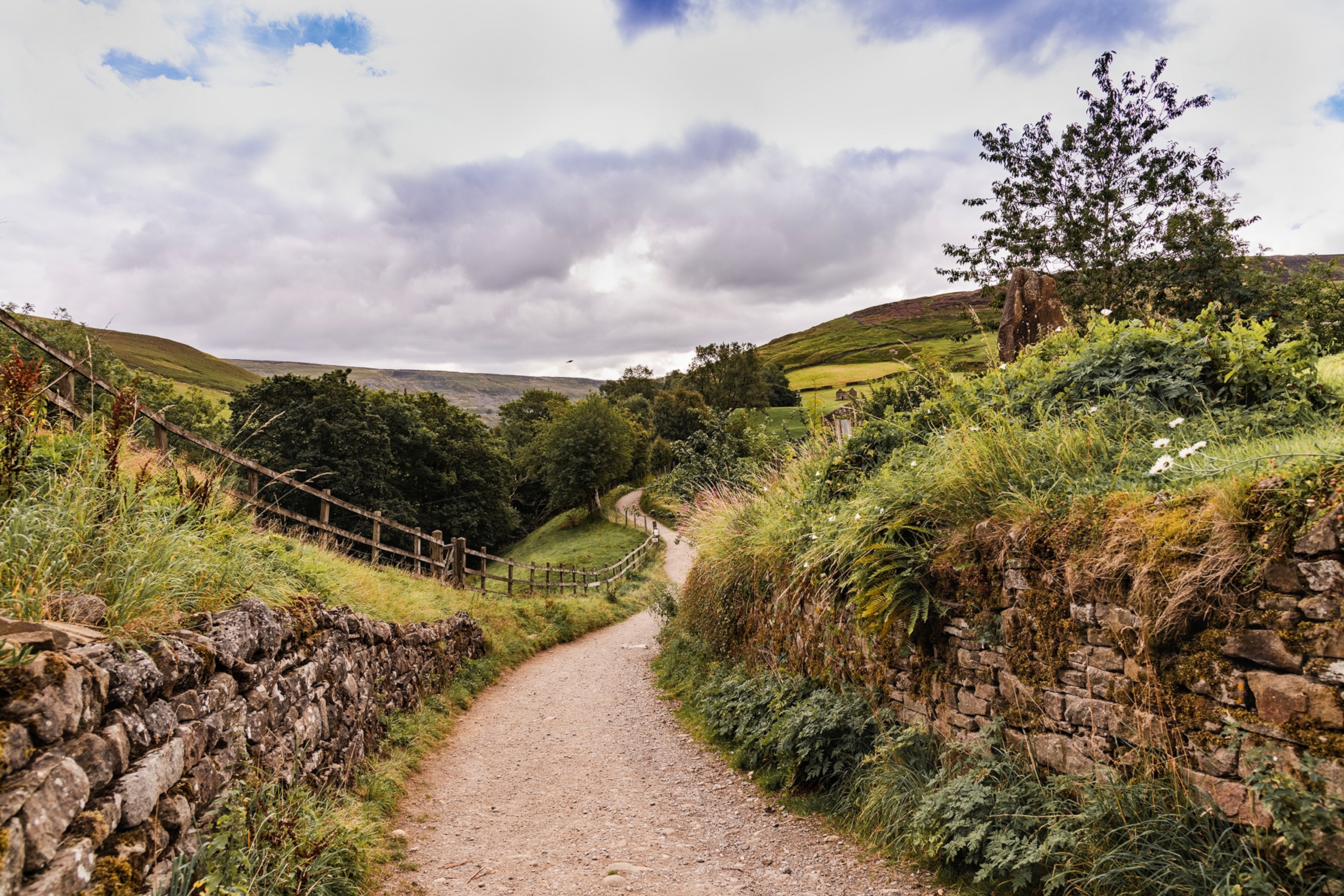 A hiking path leading along a hilly landscape.