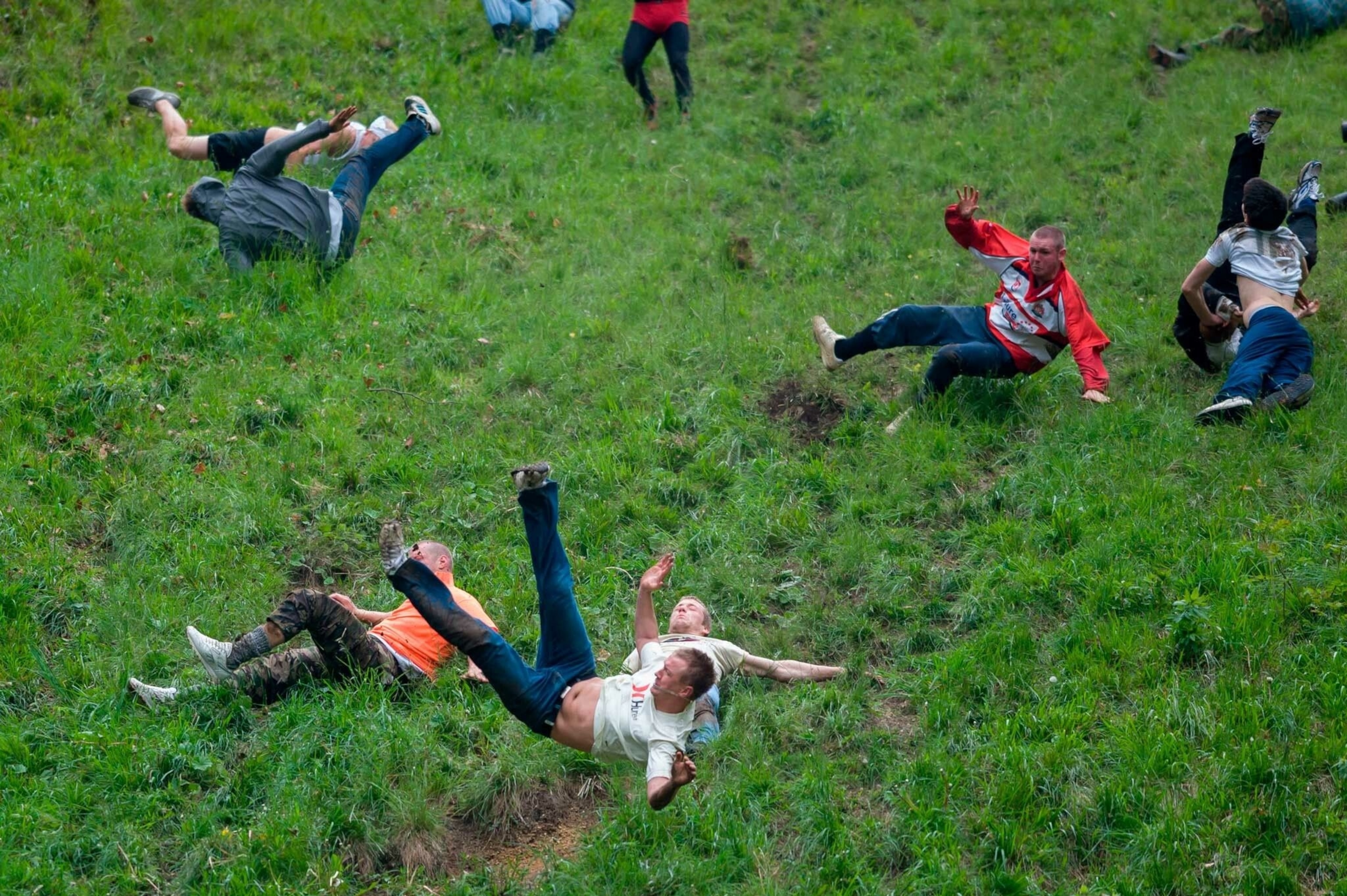 Participants chase a wheel of Double Gloucester cheese down a 200-yard hill