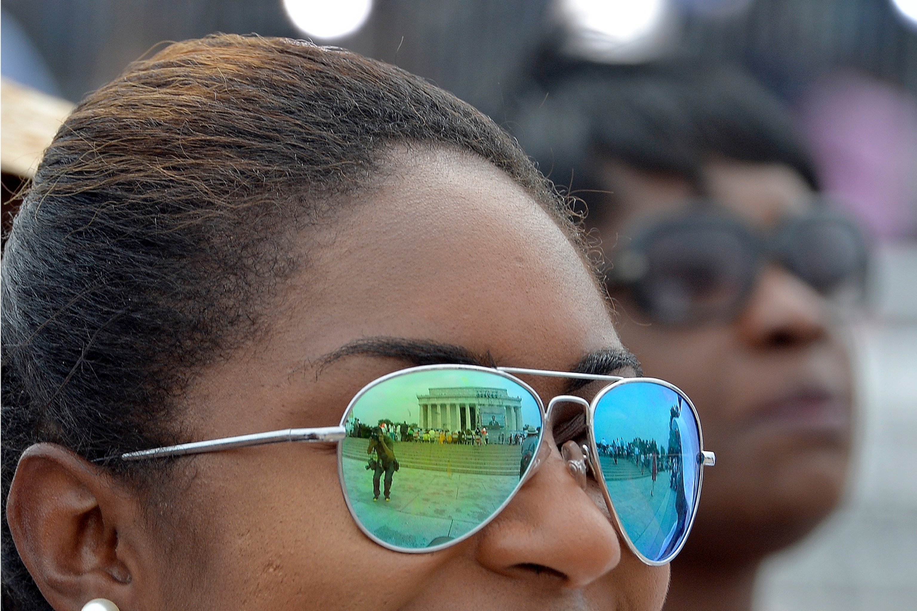 People listen to a speaker at the Lincoln Memorial in Washington, DC.