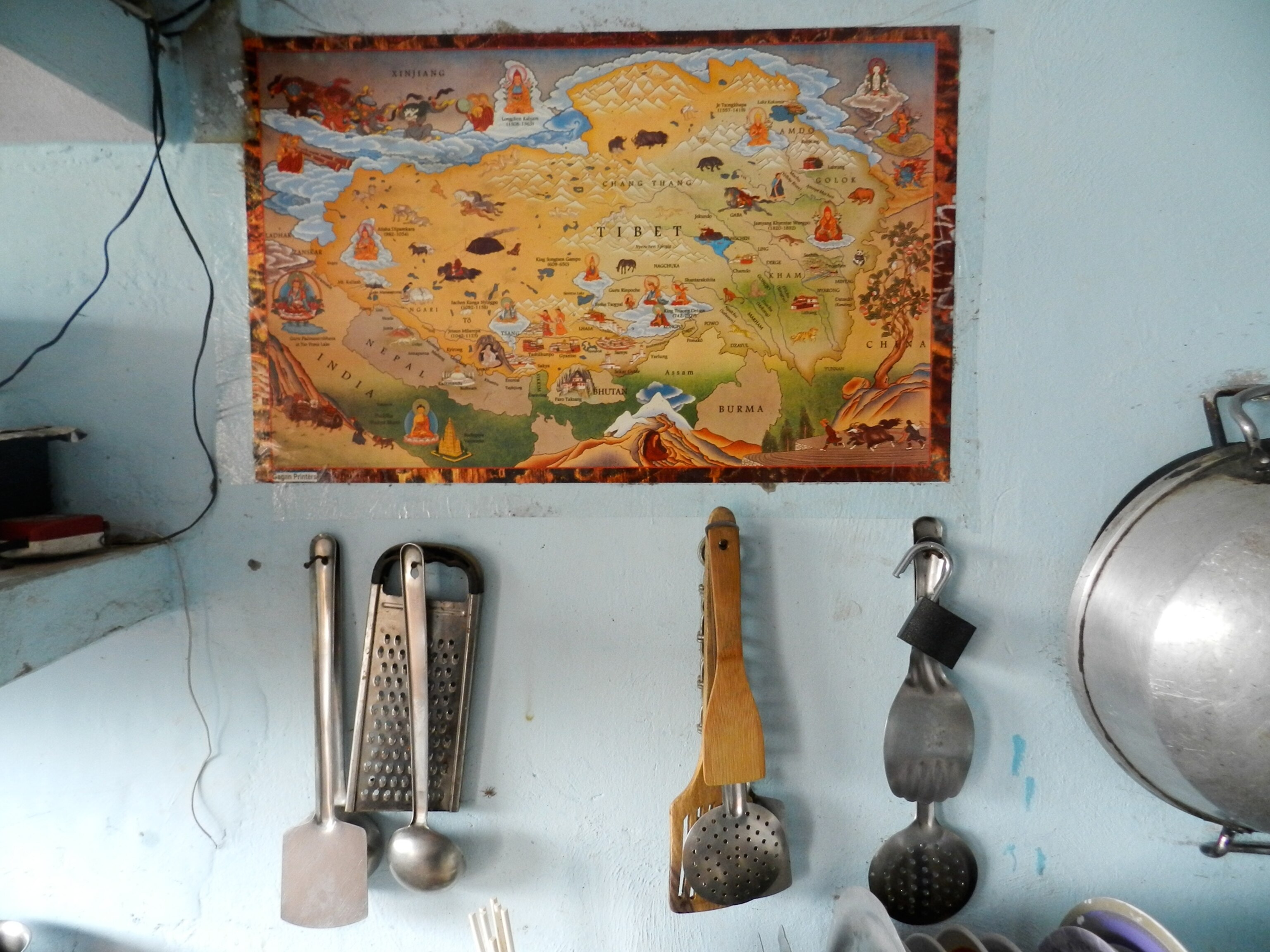 a map of Tibet hanging in a tea shop in India