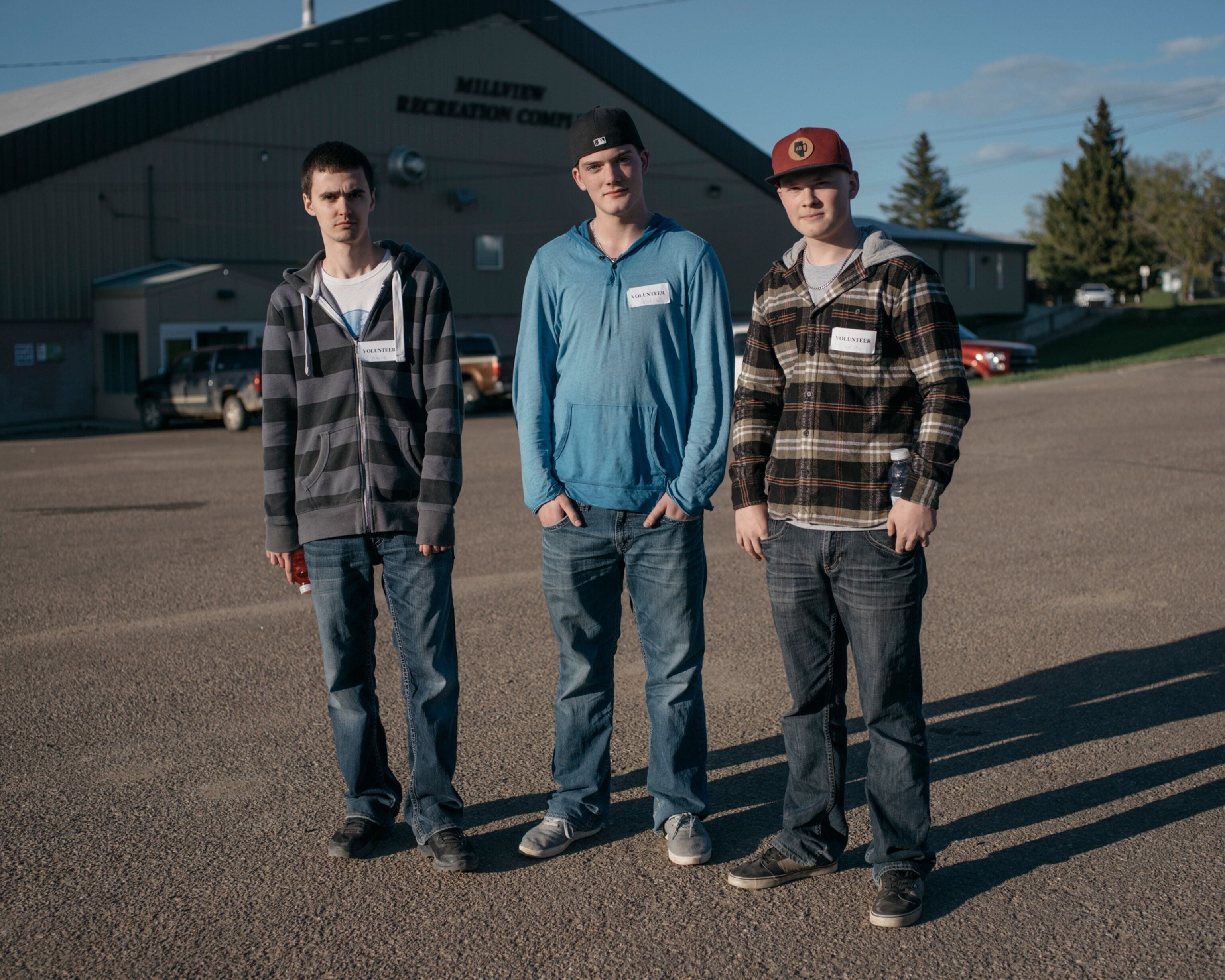 three teenage boys in a parking lot