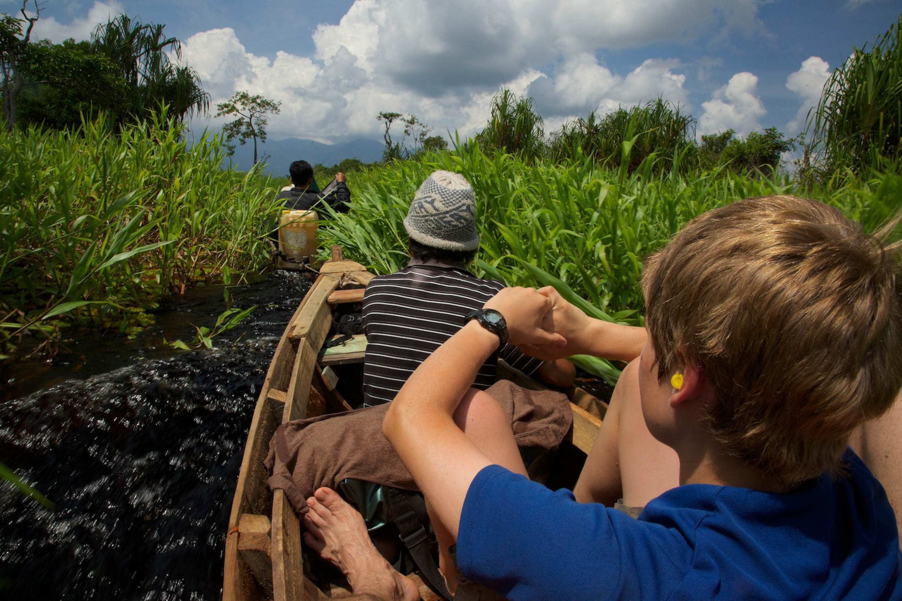 The Laman family traveling up the Air Putih river to reach the Cabang Panti Research Station. Gunung Palung National Park, West Kalimantan Province, Island of Borneo, Indonesia