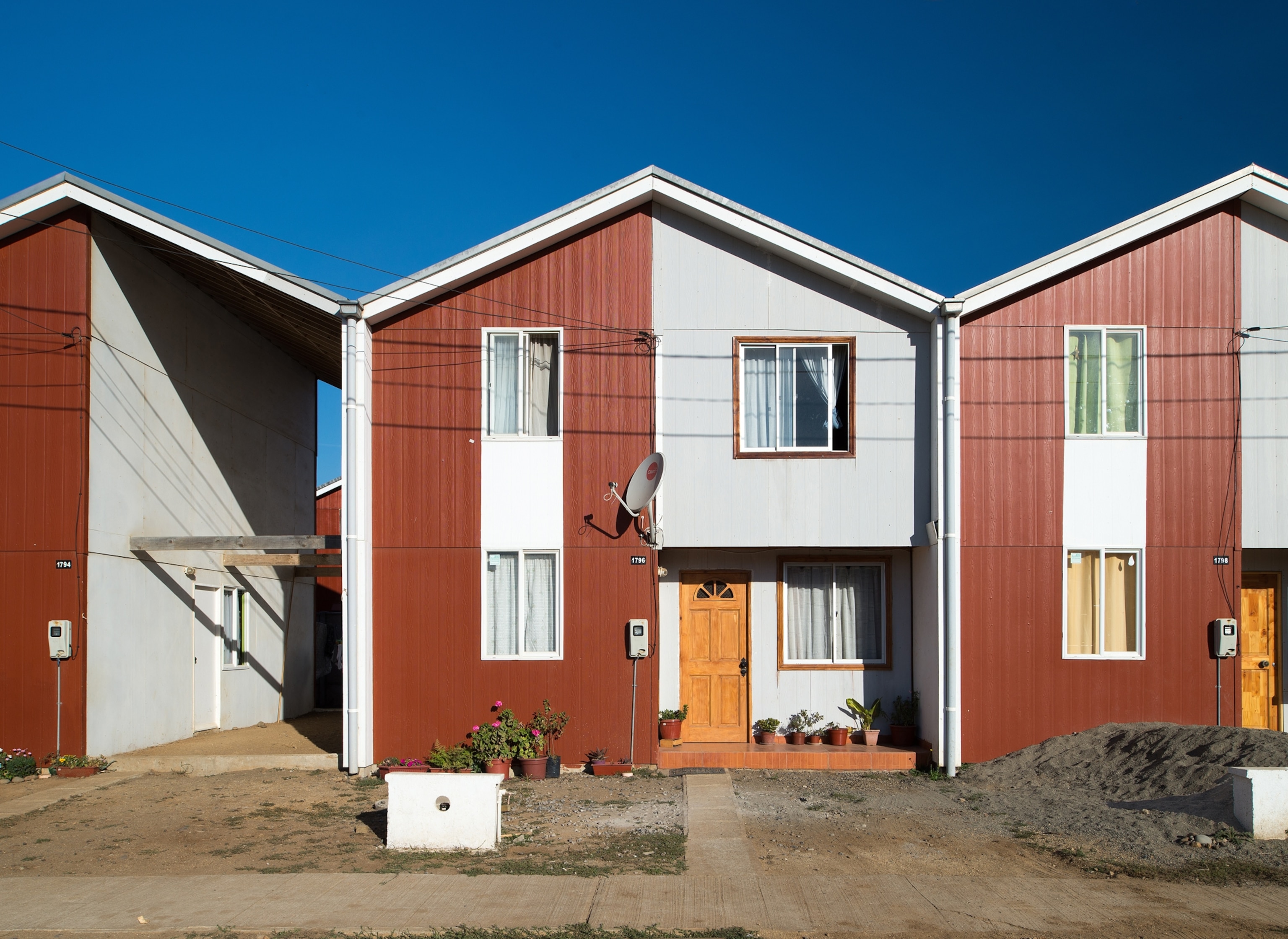 Three row-houses one of which still have unfinished empty section.