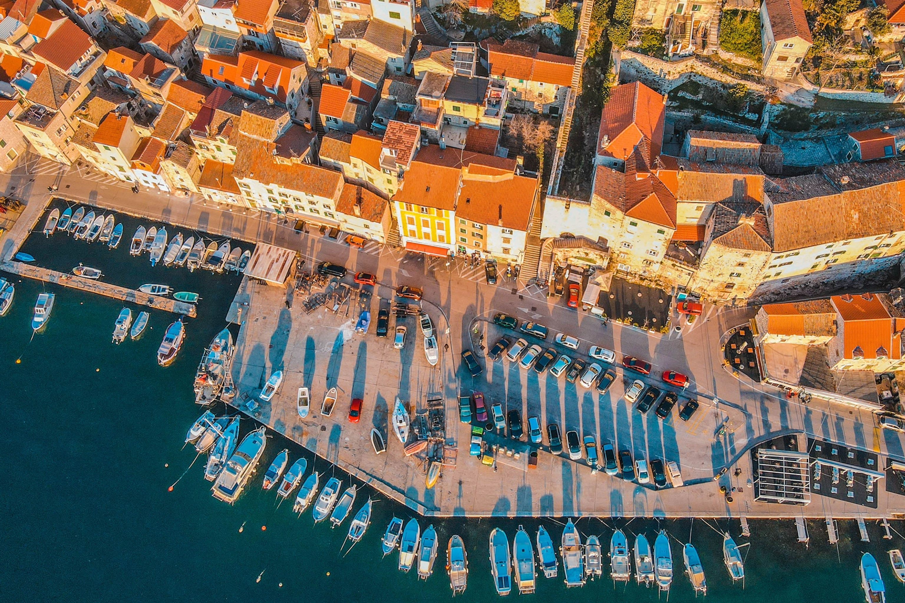 Aerial shot of a harbour with boats moored up in a seaside town