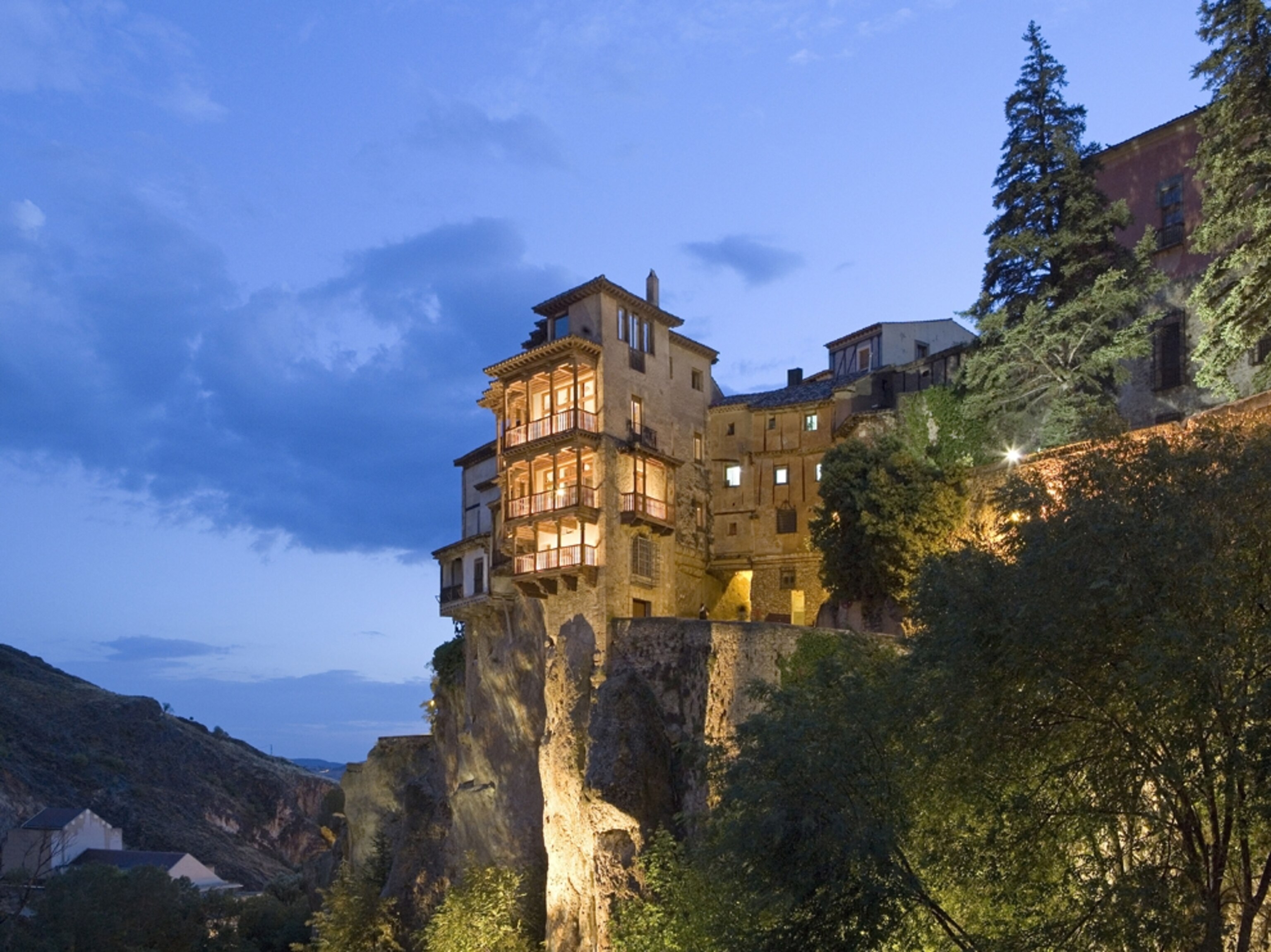 houses clinging to the side of a cliff in Cuenca, Spain