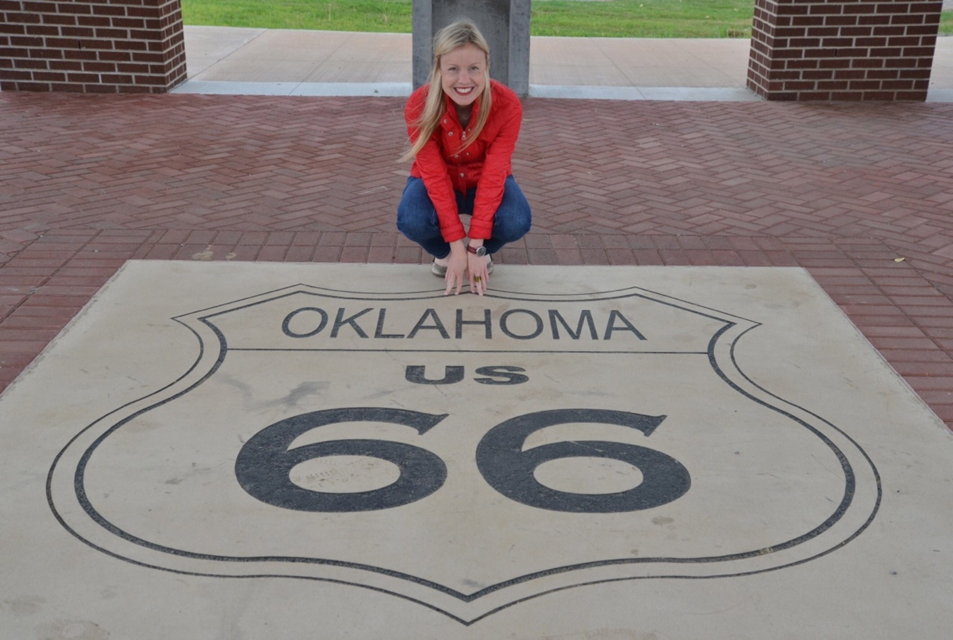 National Geographic Travel Producer Andrea Leitch stands on the Route 66 seal on Tulsa's Eleventh Street. (Photo by Andrew Evans, National Geographic Travel)