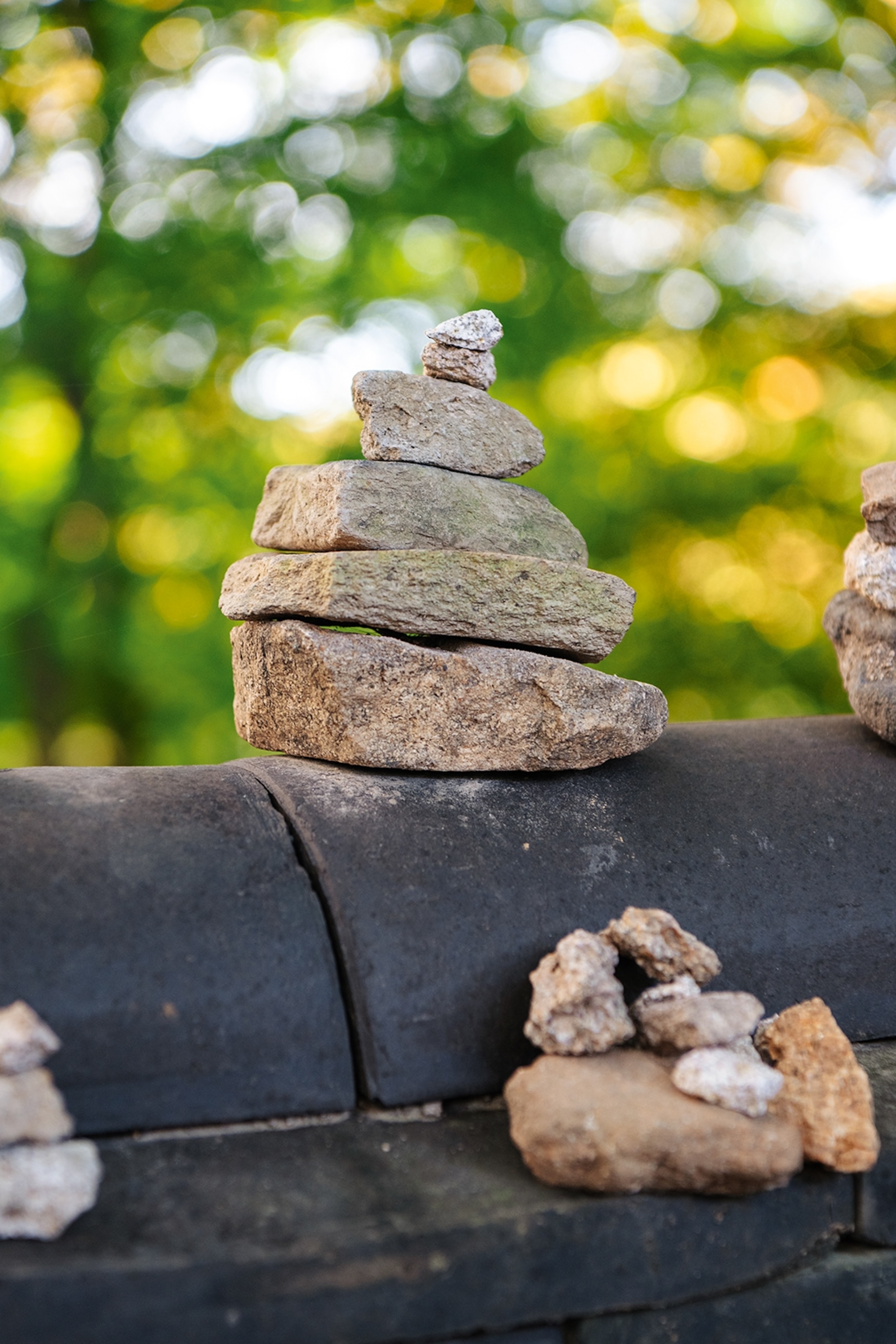 A stack of stones with trees in background.