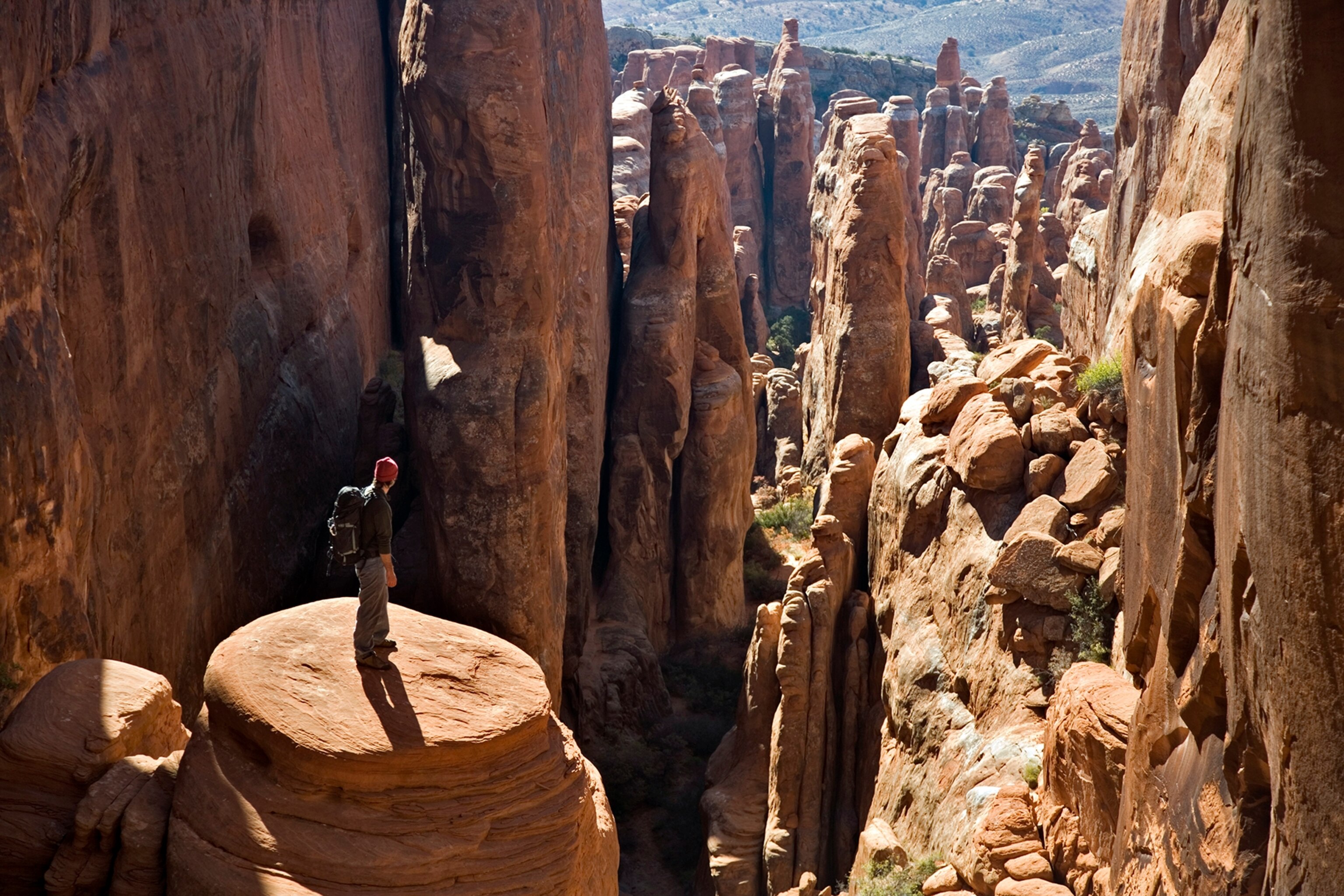 hiker overlooking Fiery Furnace, Arches National Park, Utah