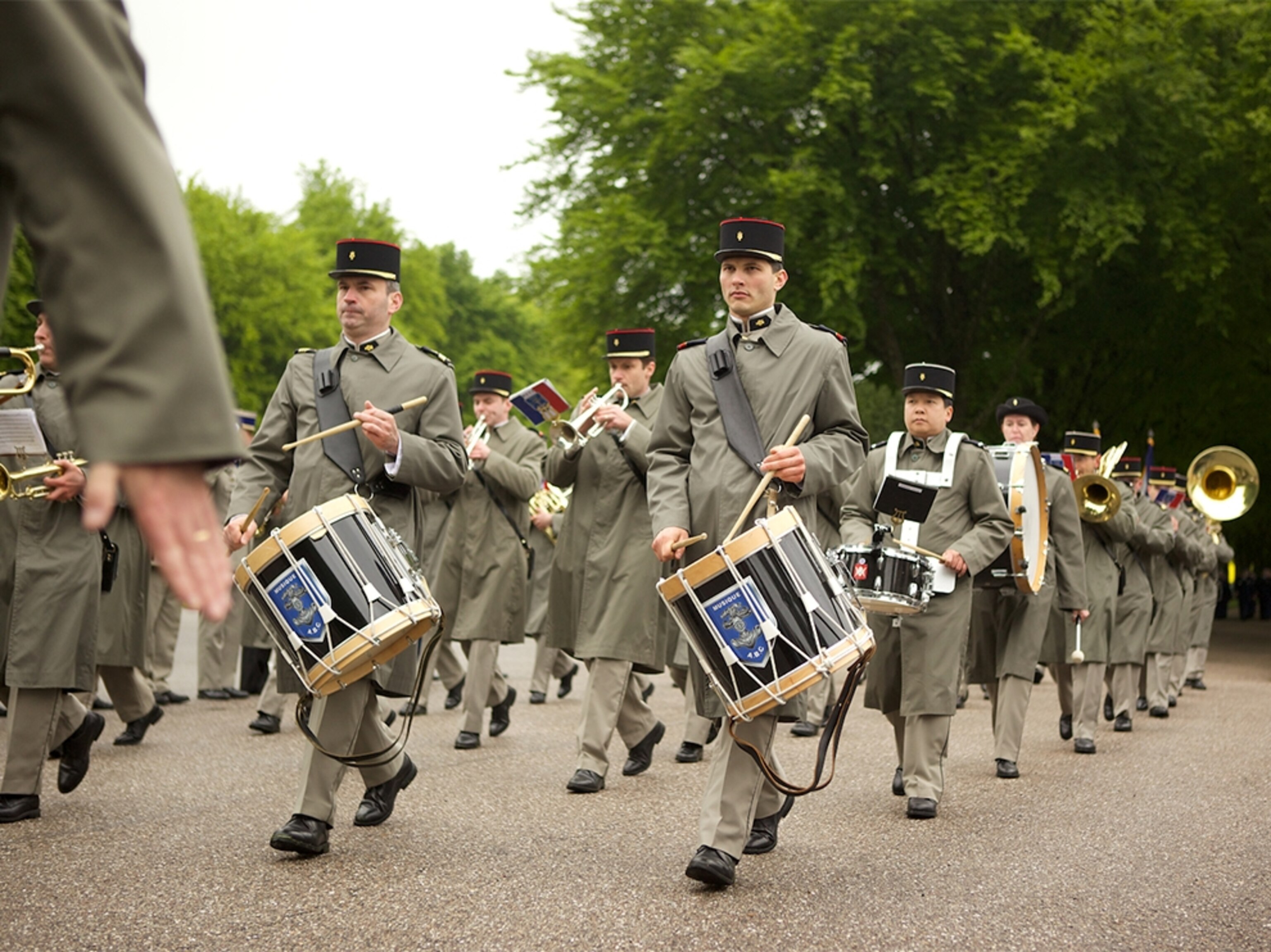 a French military band marching through the Meuse-Argonne American cemetery