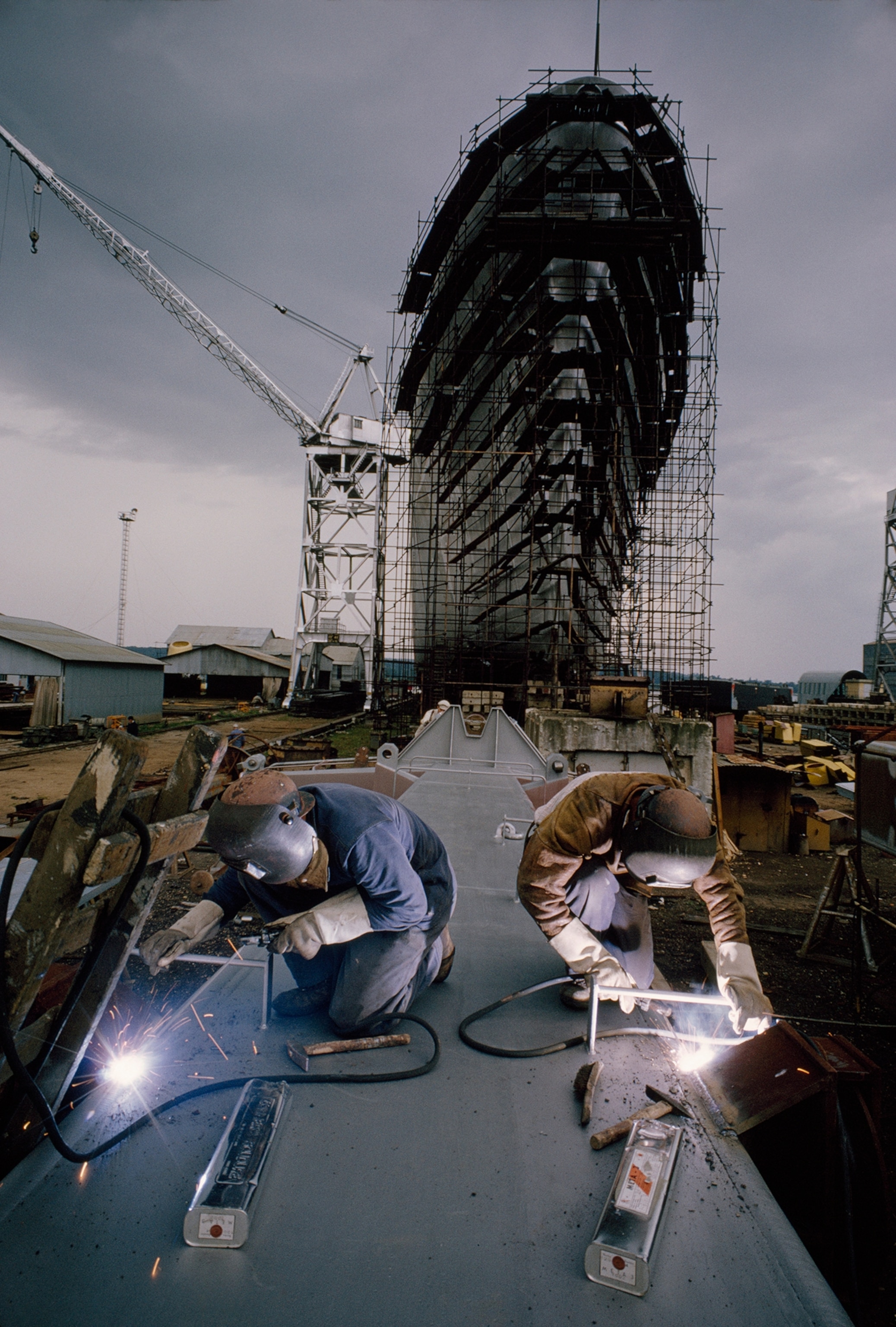 Norman welders assemble a mast for the freighter Ville de Lyon.