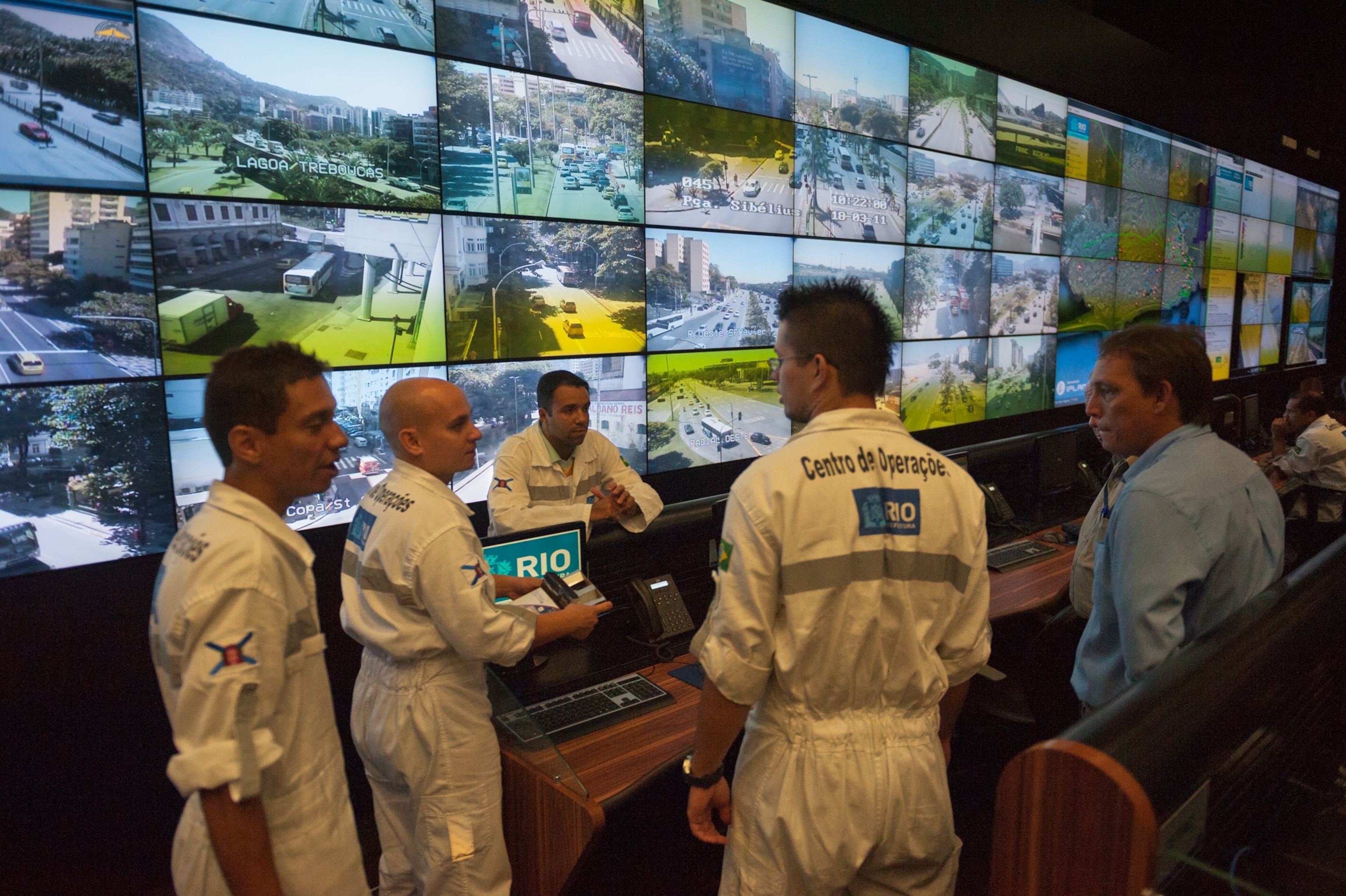 a wall of video screens in Rio's operations center