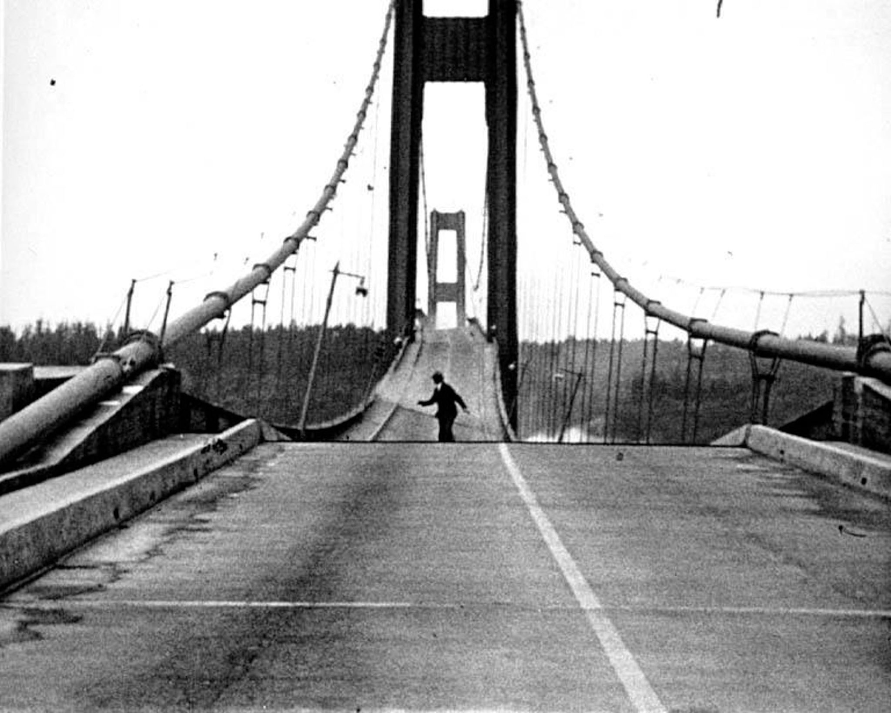 This dramatic photograph shows Howard Clifford running off the Tacoma Narrows Bridge during its collapse in 1940, an event known as 'Galloping Gertie' due to the bridge's violent movement in a windstorm.