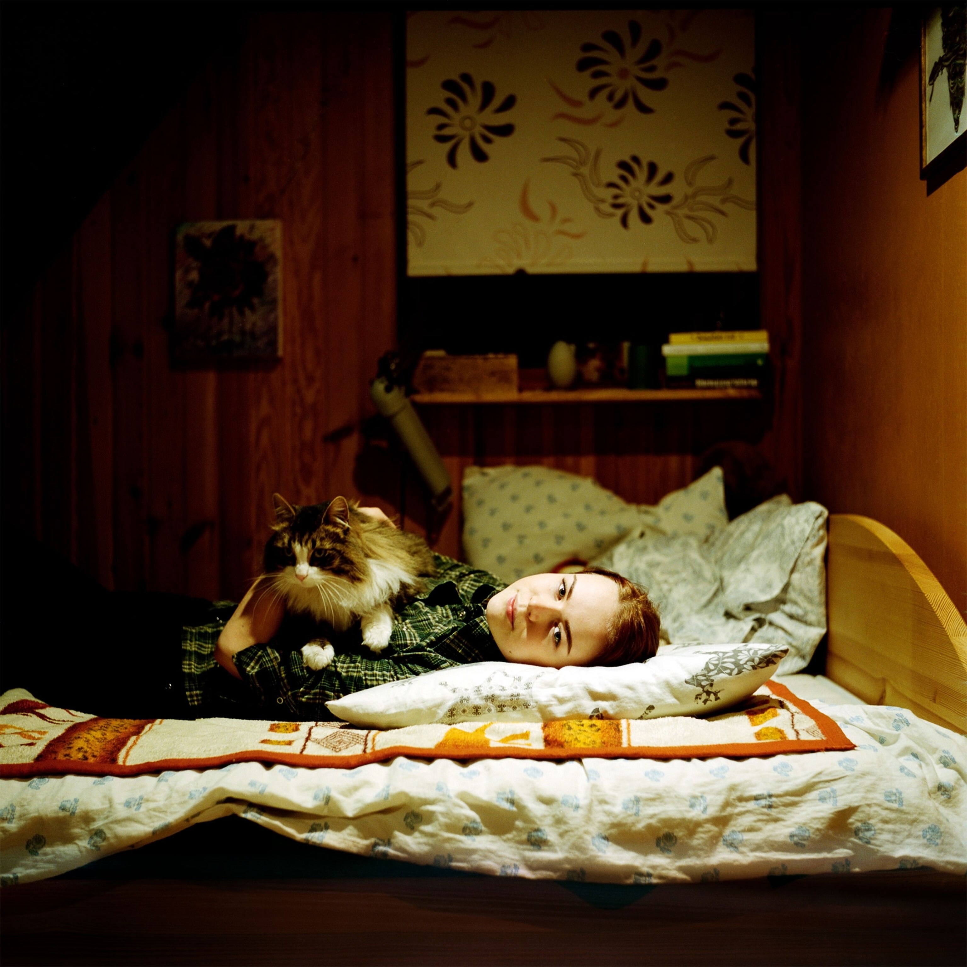 a woman laying down with a cat