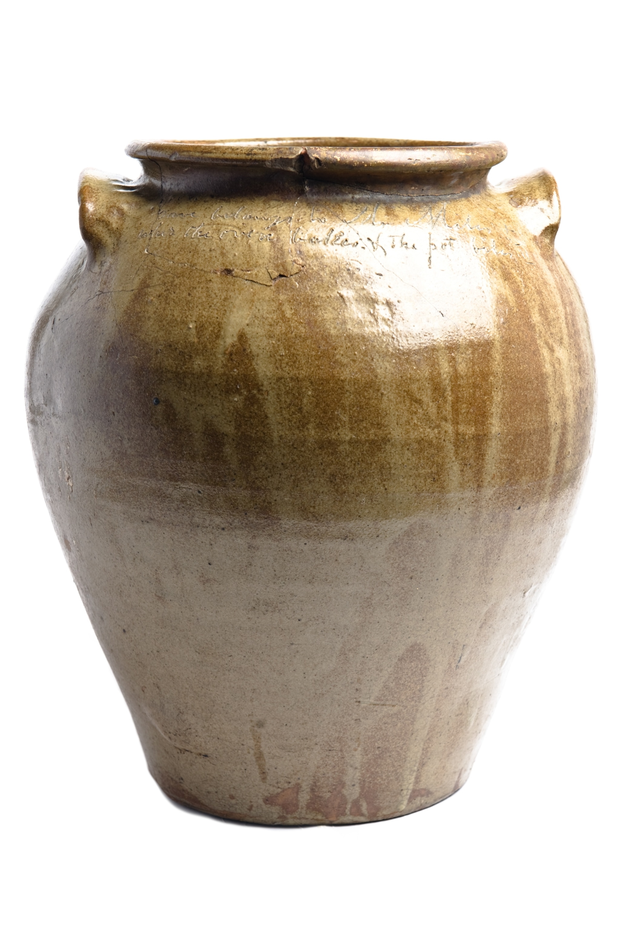 A ceramic pot with the engraving, "Dave belongs to Mr. Miles, wher the oven bakes and the pot biles."
