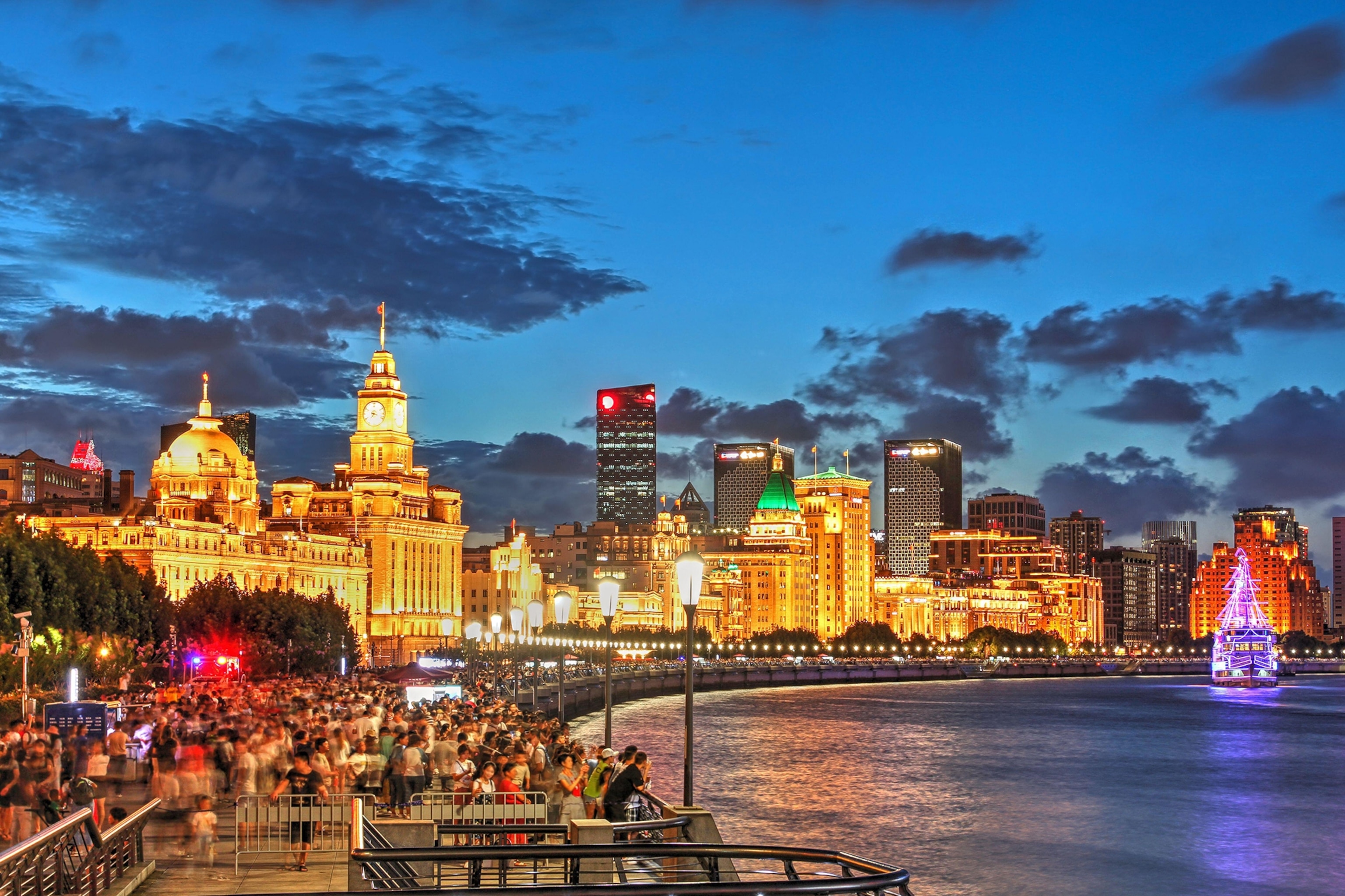 Night scene along the Bund in Shanghai, China, featuring most of the iconing collonial buildings facing the Huangpu River.