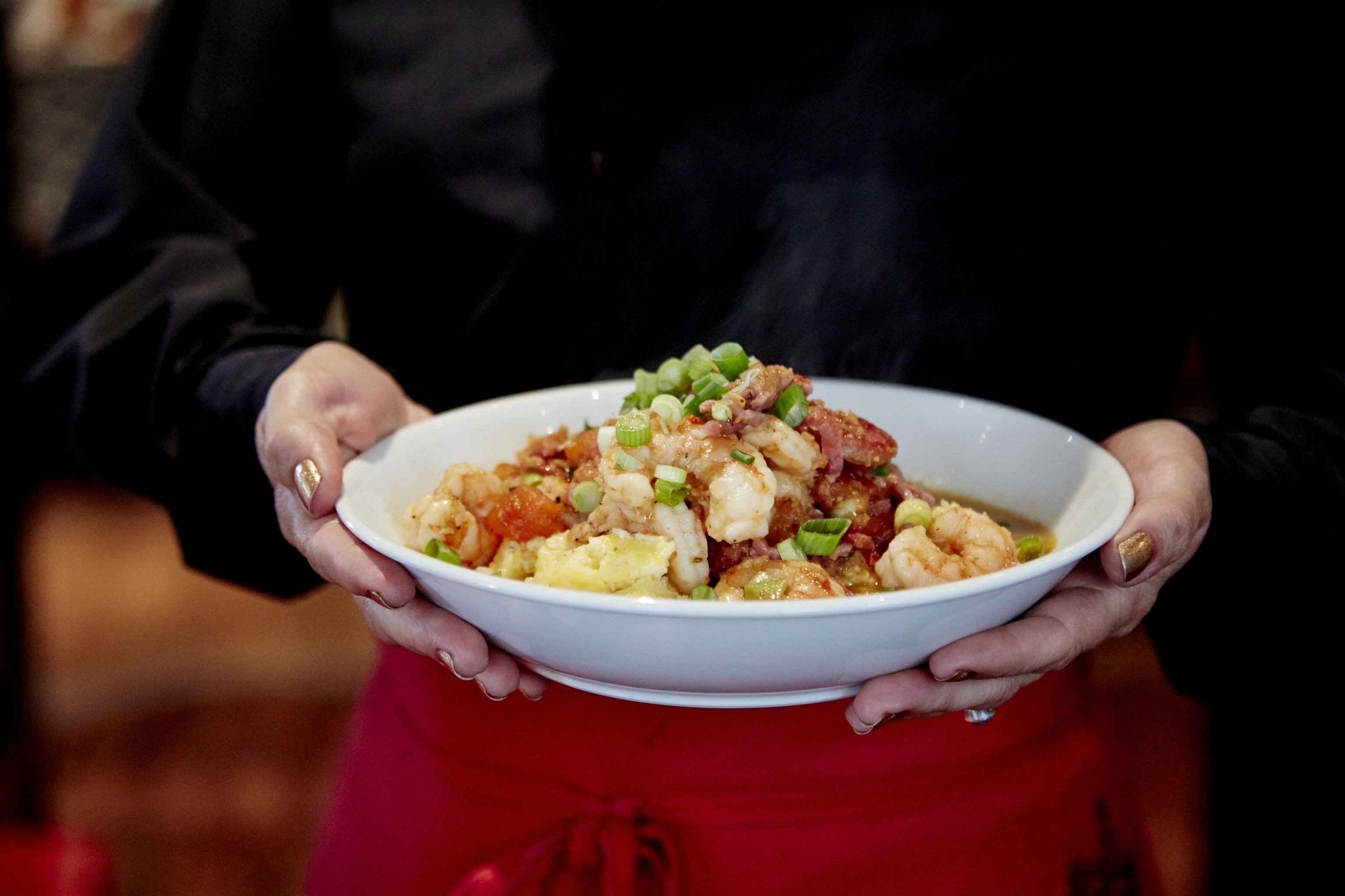 Shrimps and grit served in a white bowl.