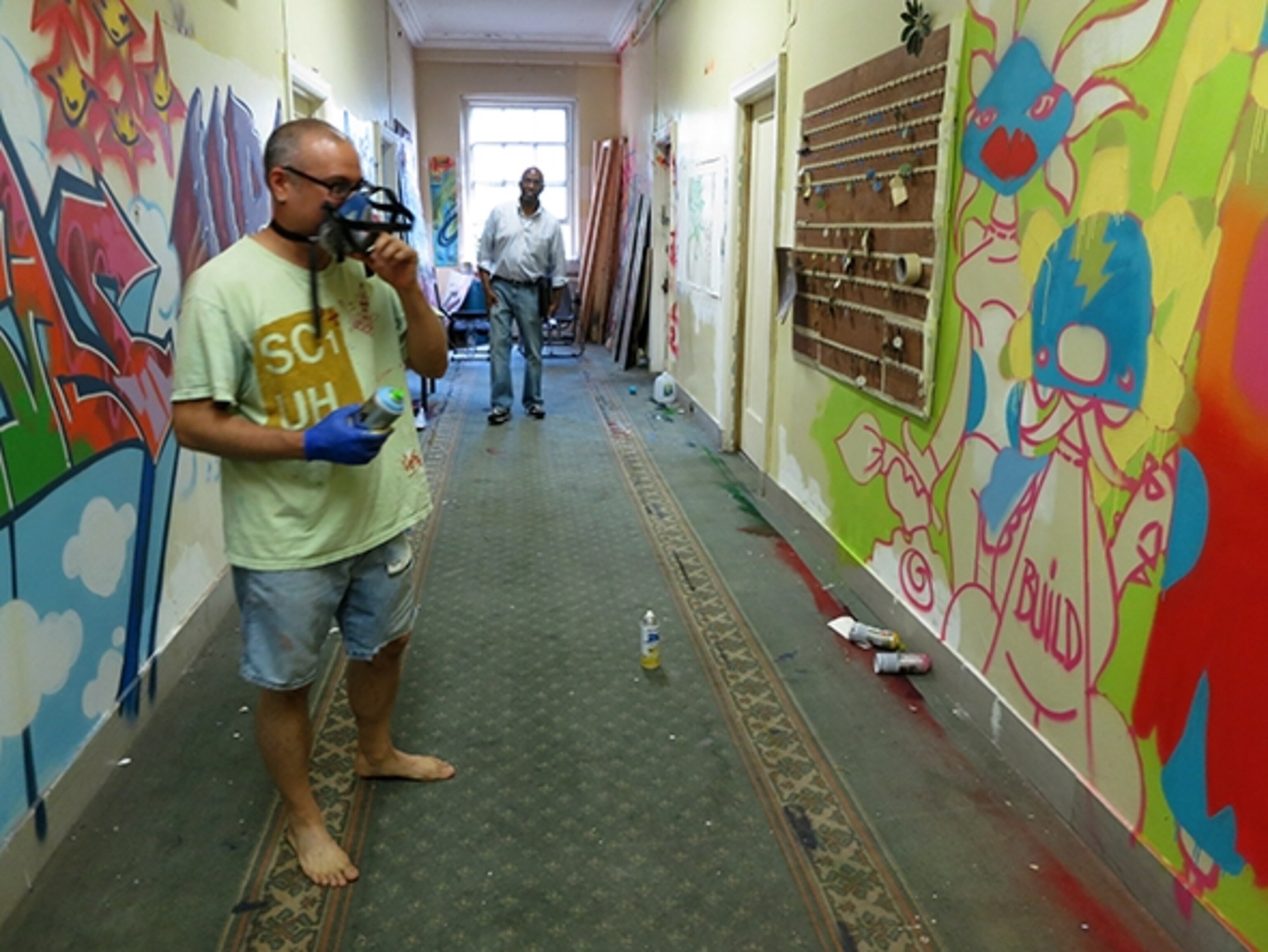 SpazeCraft, who runs graffiti art classes for local kids at the Andrew Freedman Home in the Bronx, shows off a work in progress. (Photograph by Robert Reid)