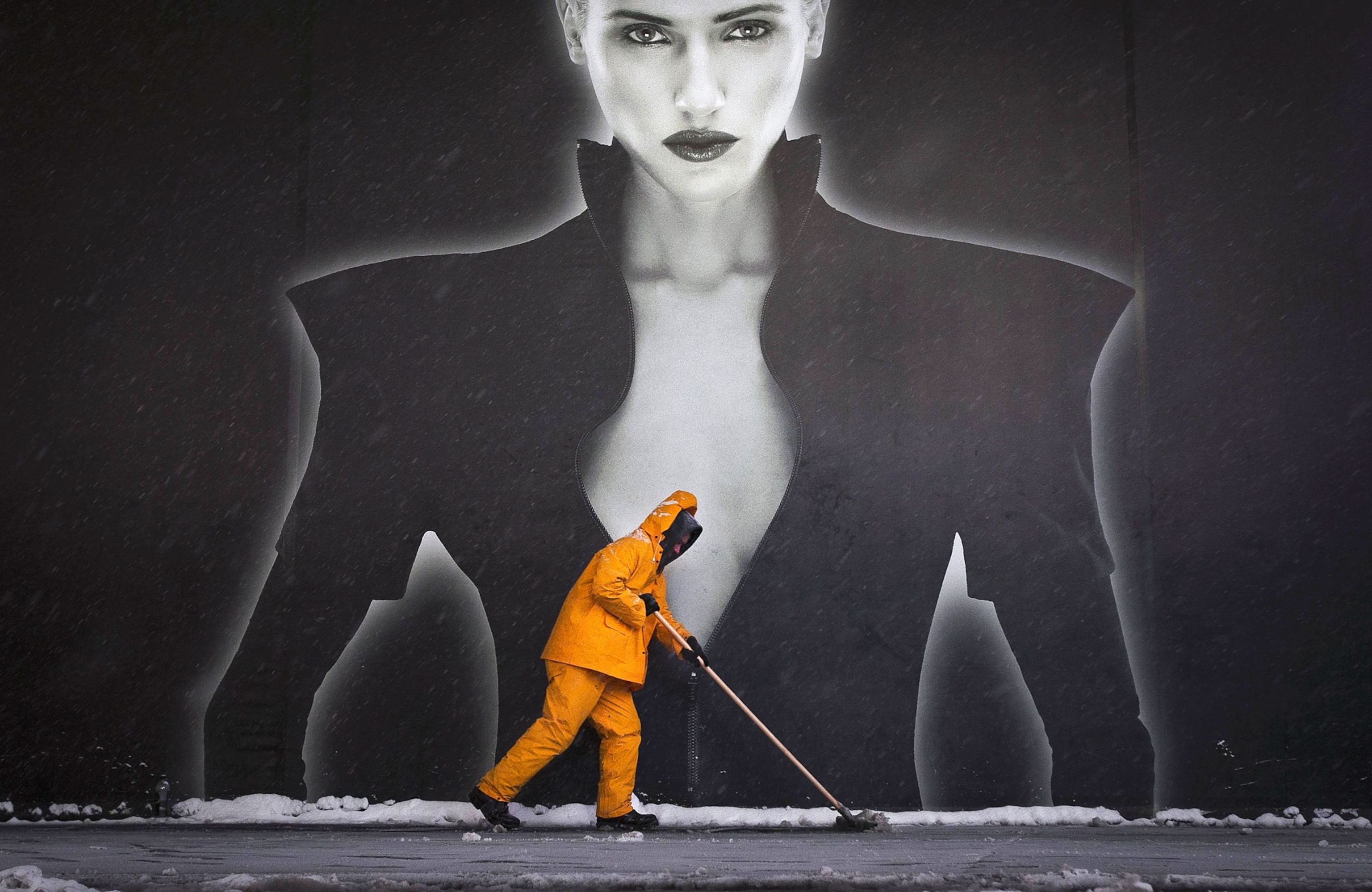 a worker cleaning the sidewalk in front of a billboard in Times Square in New York City on Friday