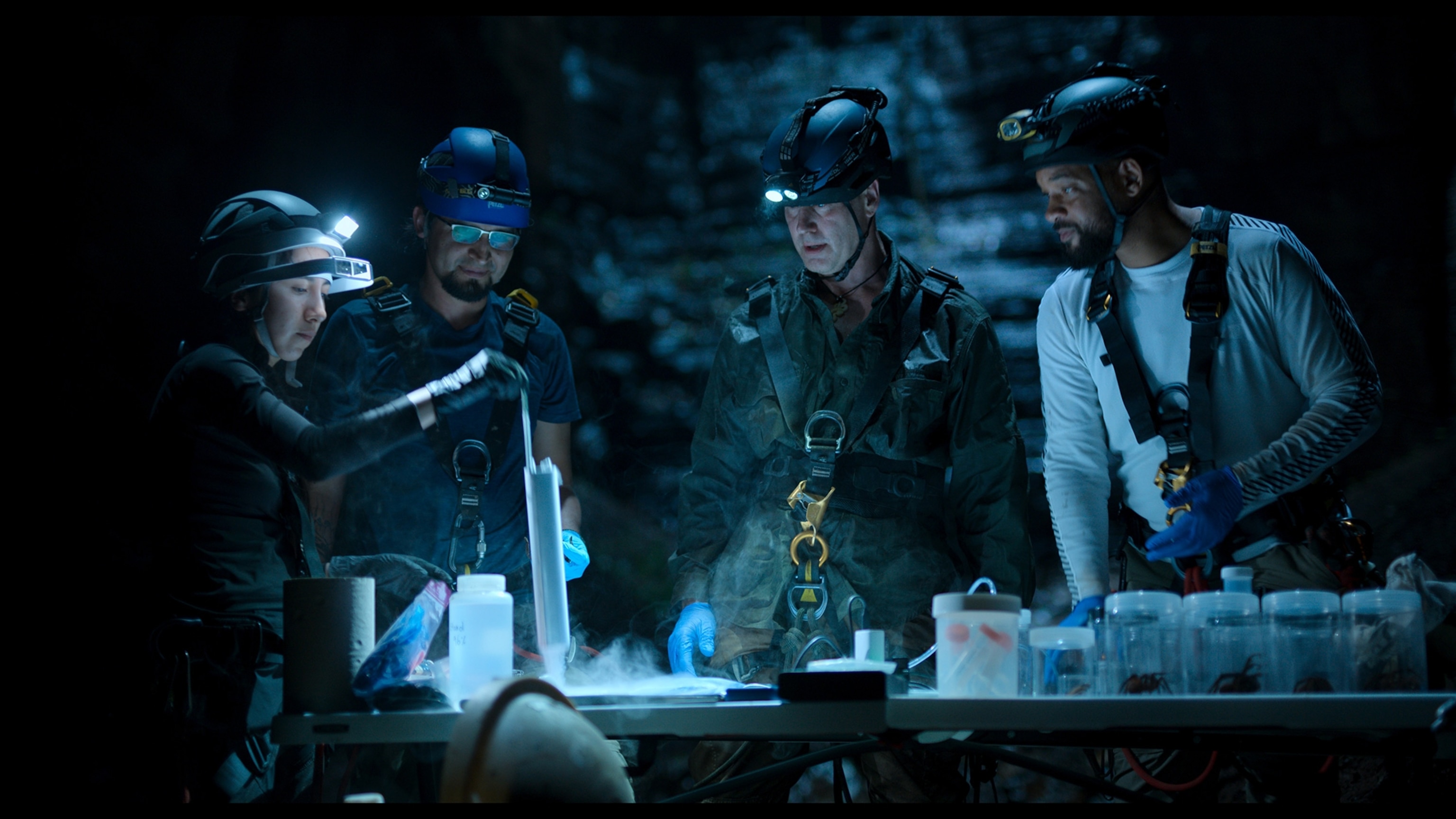 Bryan Fry, his scientists and Will Smith prepare to milk a tarantula, whose venom is being researched as a source for new medicines. 