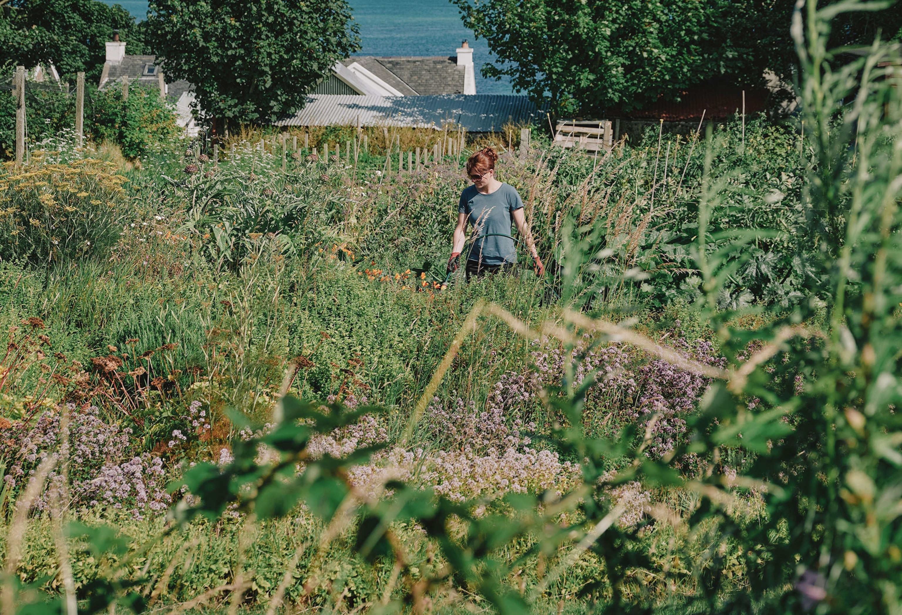 A woman with pale skin in a garden.