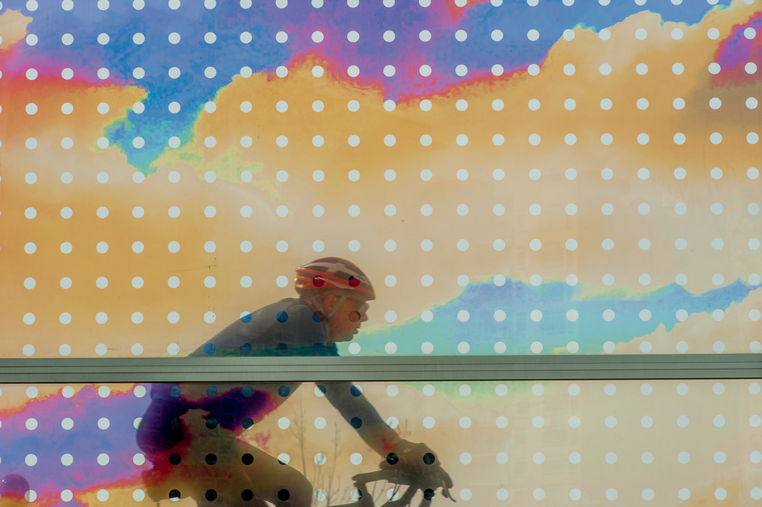 A bicycle going over the Seattle Cloud Cover, an outdoor glass bridge and sculpture by American artist Teresita Fernandez, installed at the Olympic Sculpture Park on the waterfront in Seattle, Washington State, USA.