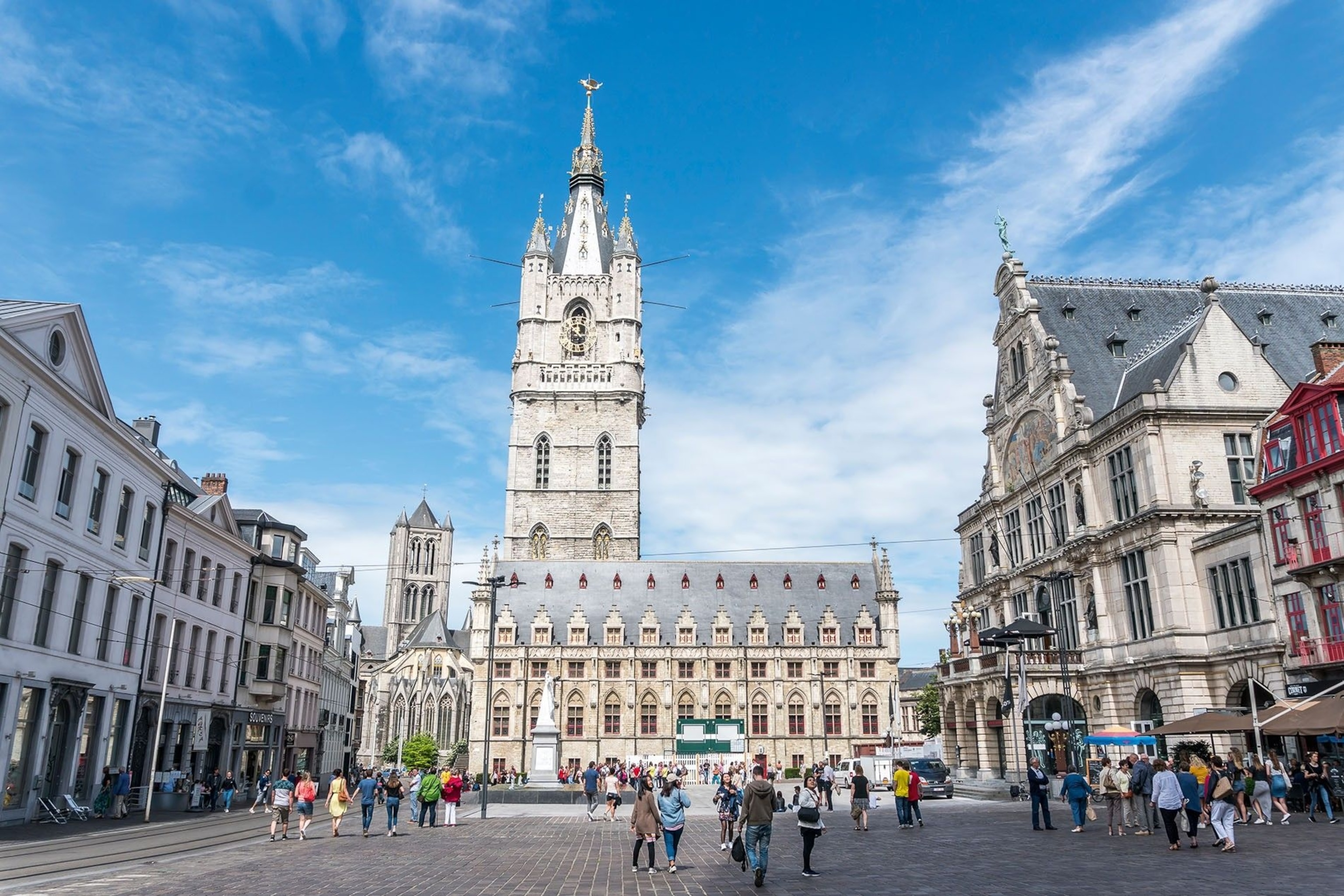 Picturesque Sint-Baafsplein in the Belgian city of Ghent is dominated by the dramatic gothic architecture of St Bavo's Cathedral.