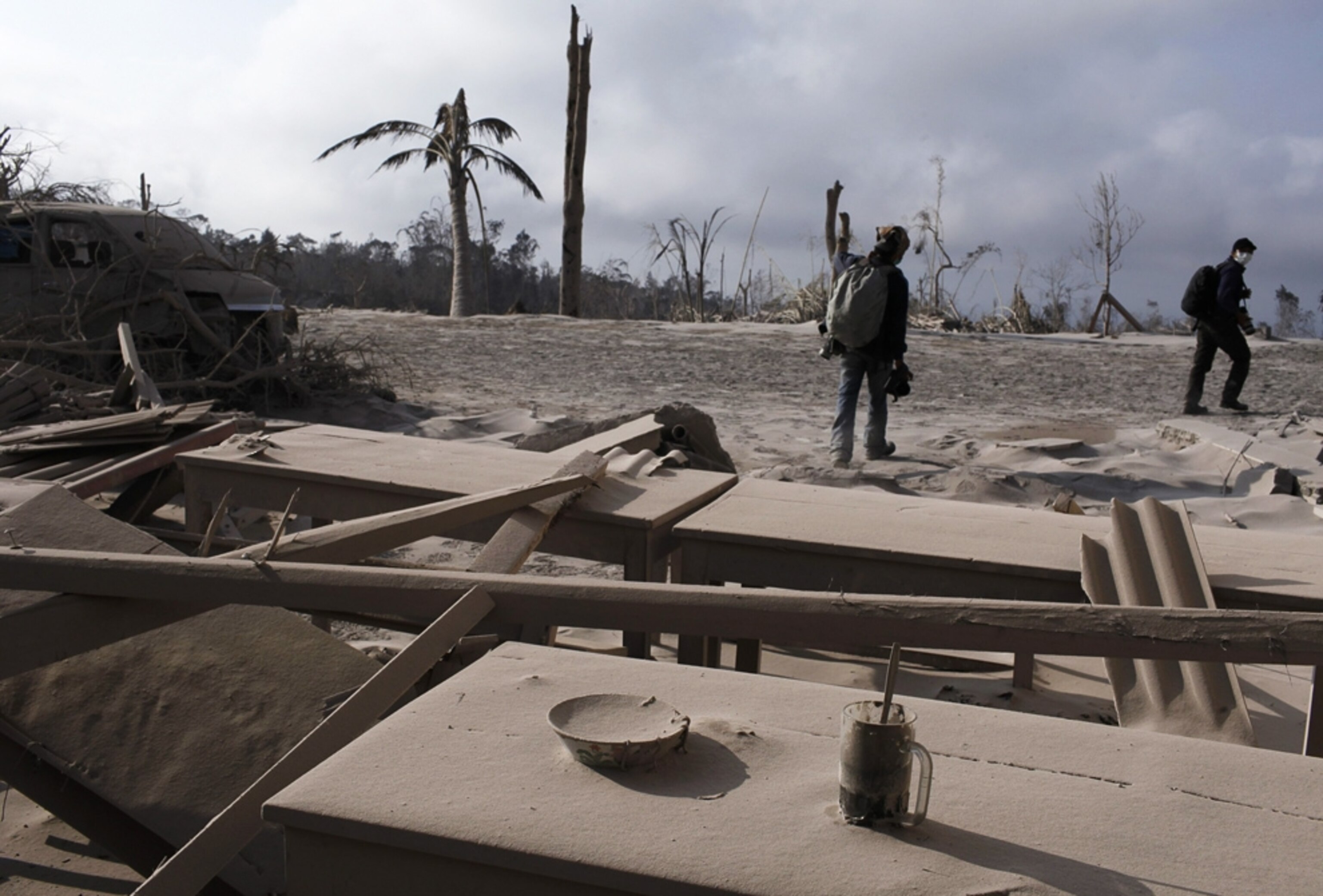 an ash-covered drinking glass and bowl of noodles following the eruption of Mount Merapi in Indonesia.