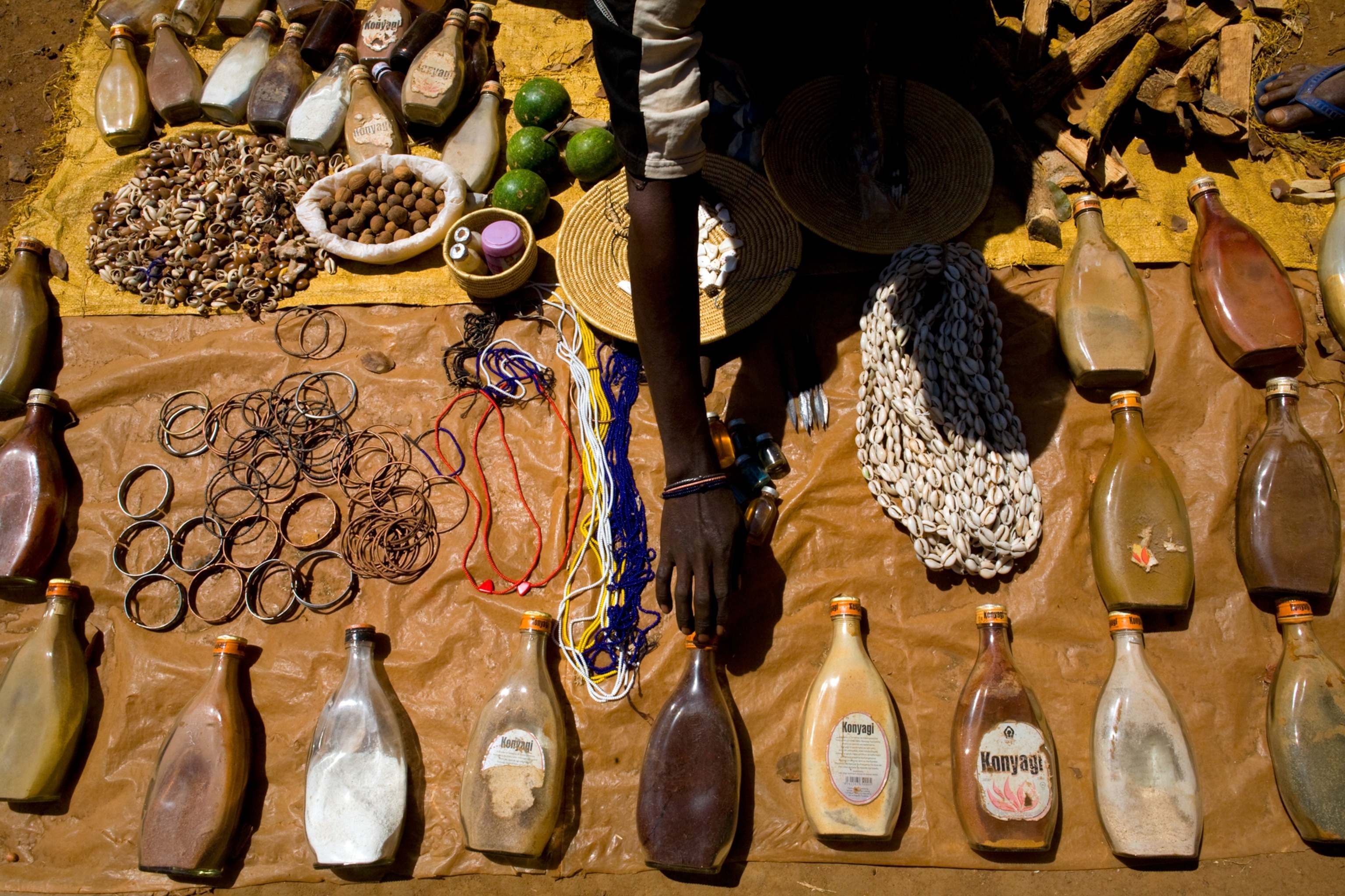 gold traders selling cures in a market to make money