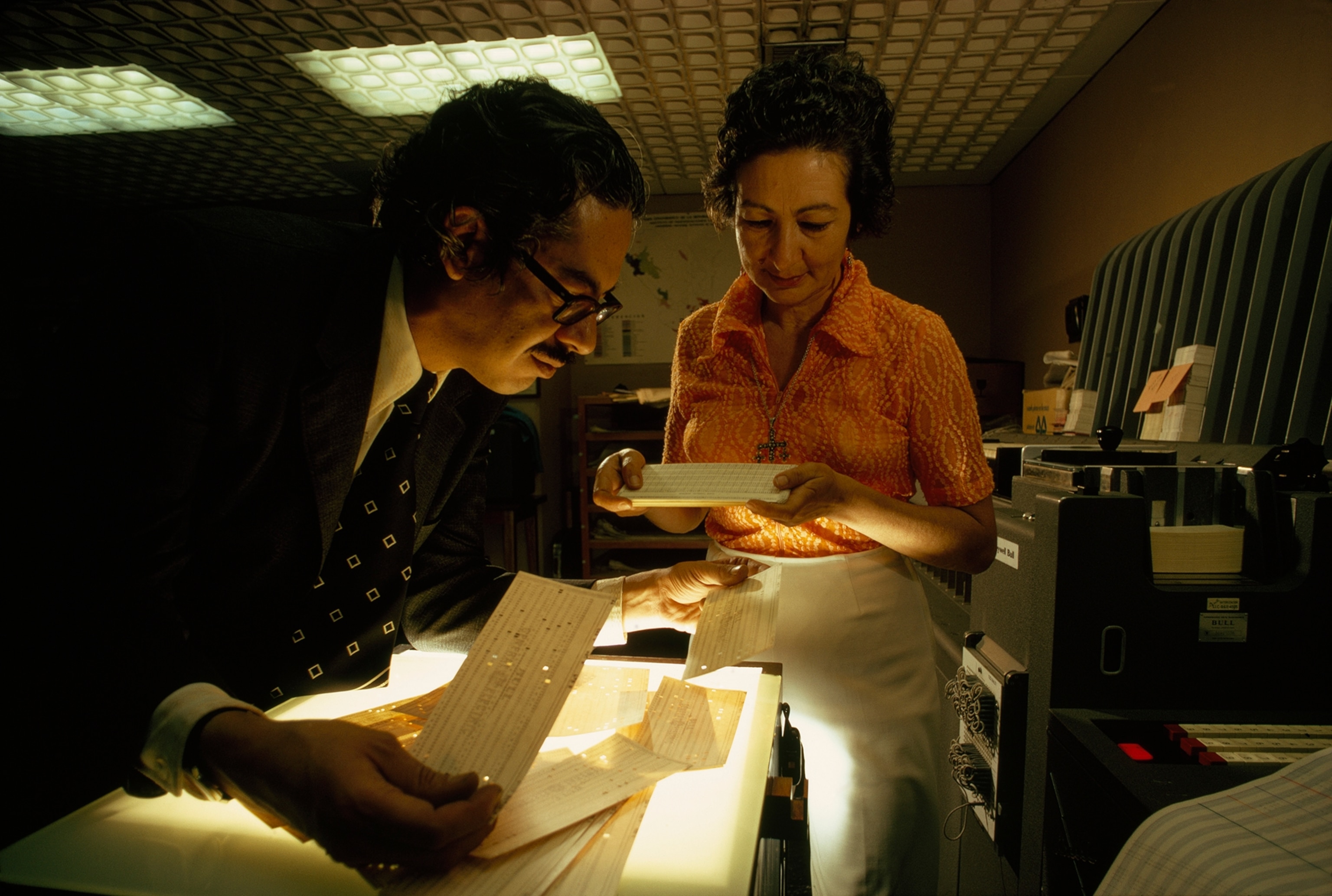 Another aid, a computer, analyzes glyphs for Professor Leonardo Manrique and Cristina Álvarez Lomelí of Mexico's National Institute of Anthropology and History.