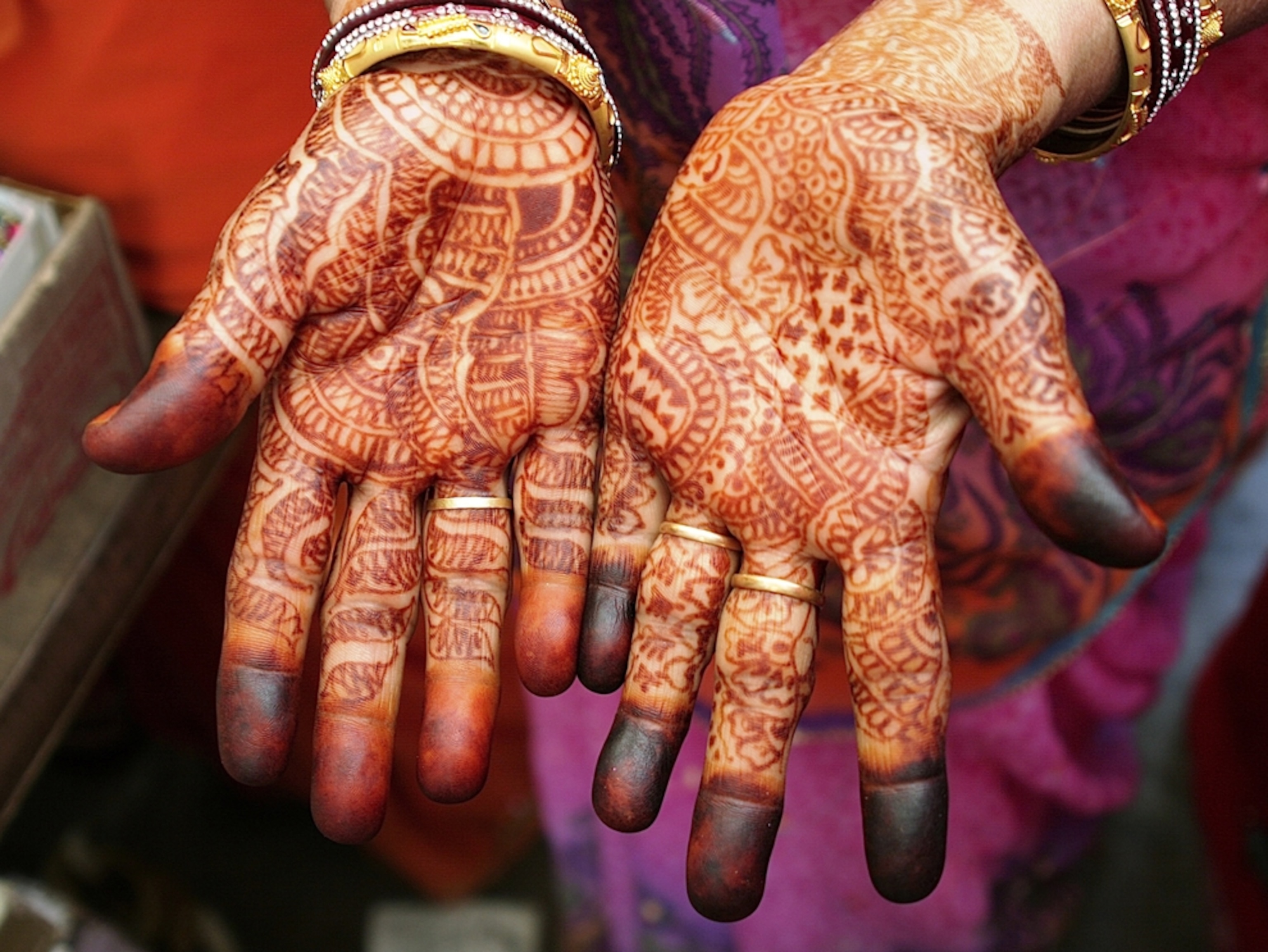 Two hands covered in henna
