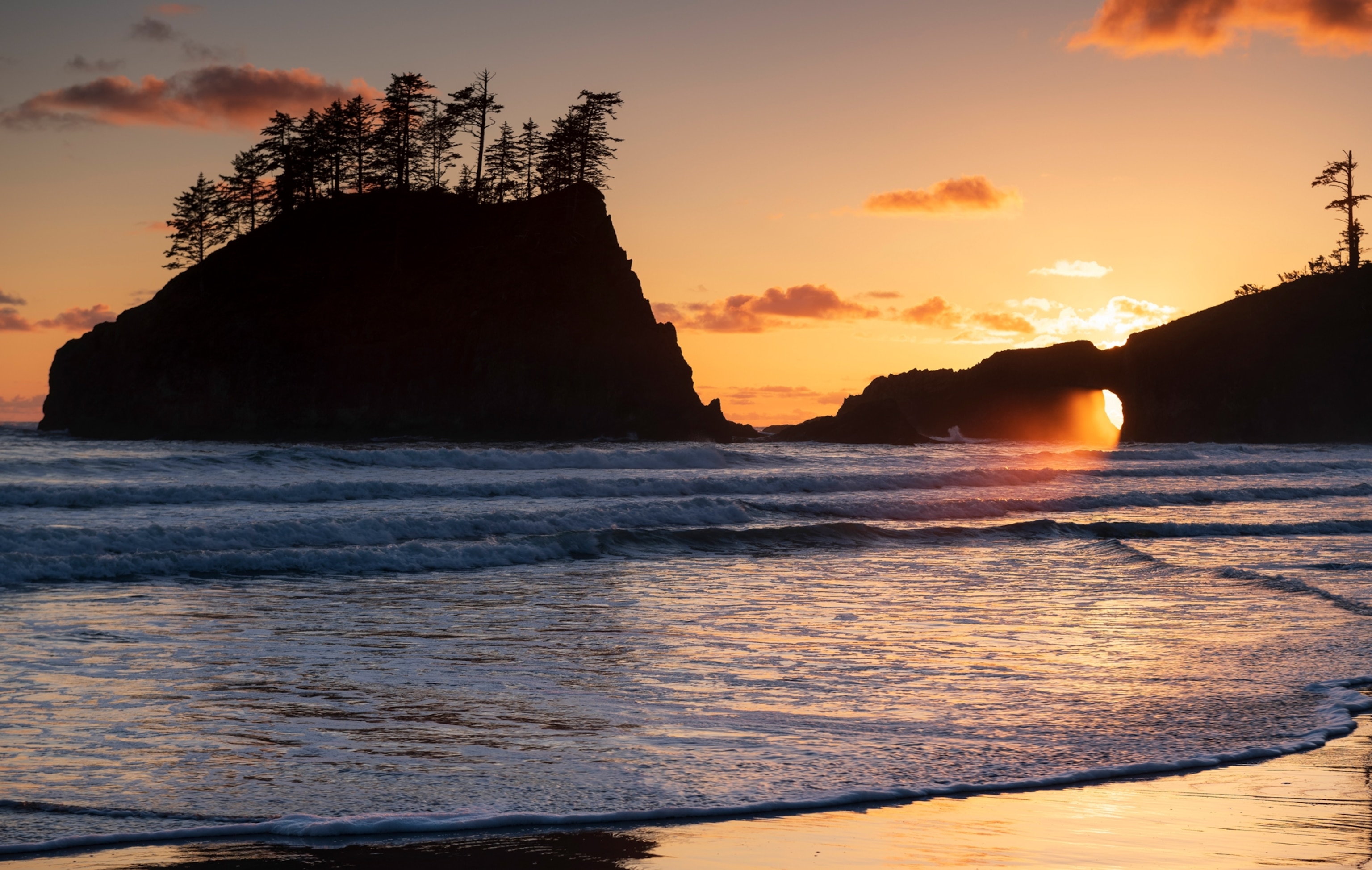 sSunlight streaming through rock formations on Second Beach near La Push