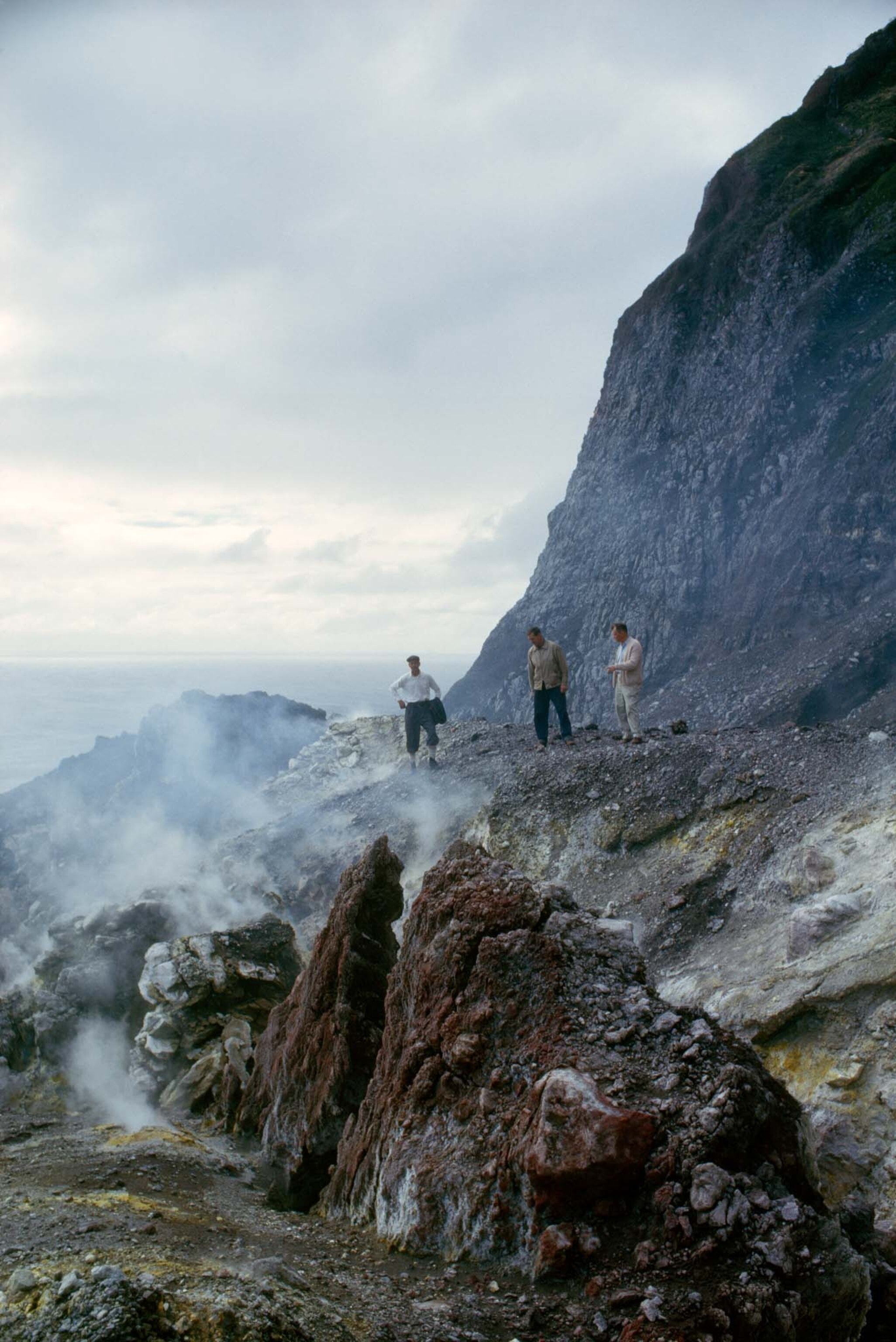 men looking at volcano