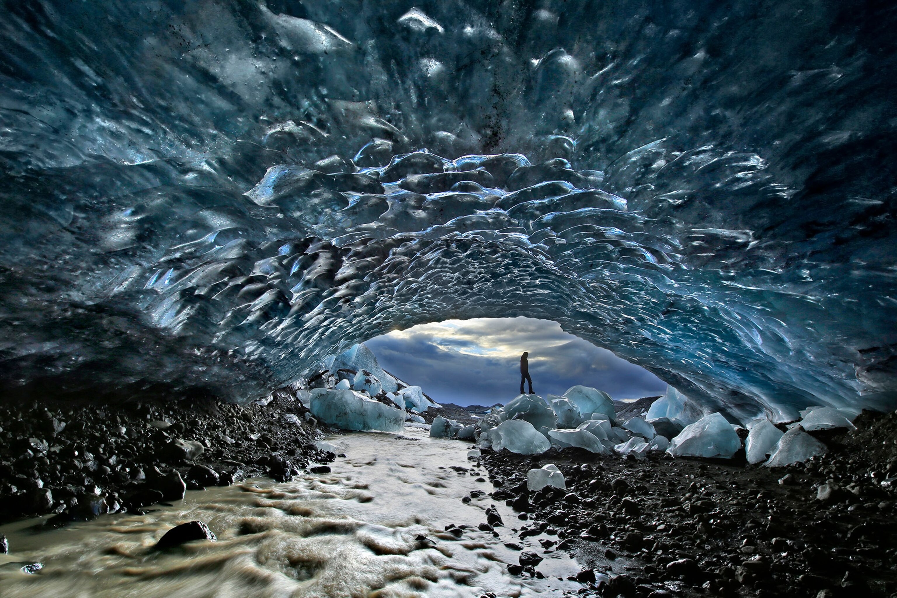 person standing in an ice cave in Iceland