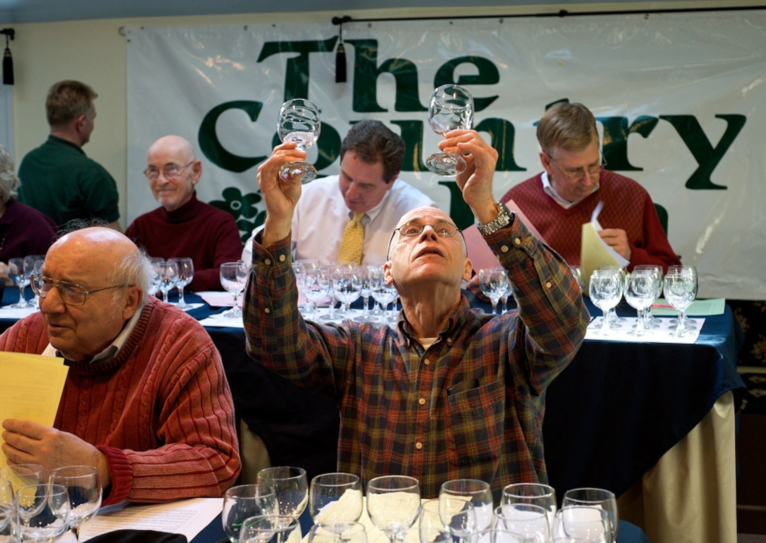 A man holding up two glasses of water