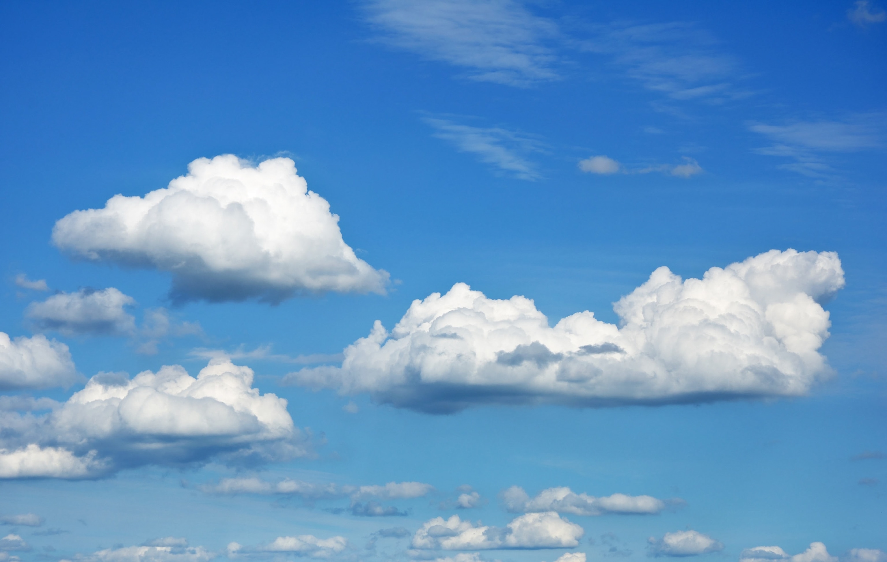 cumulus clouds against a blue sky.