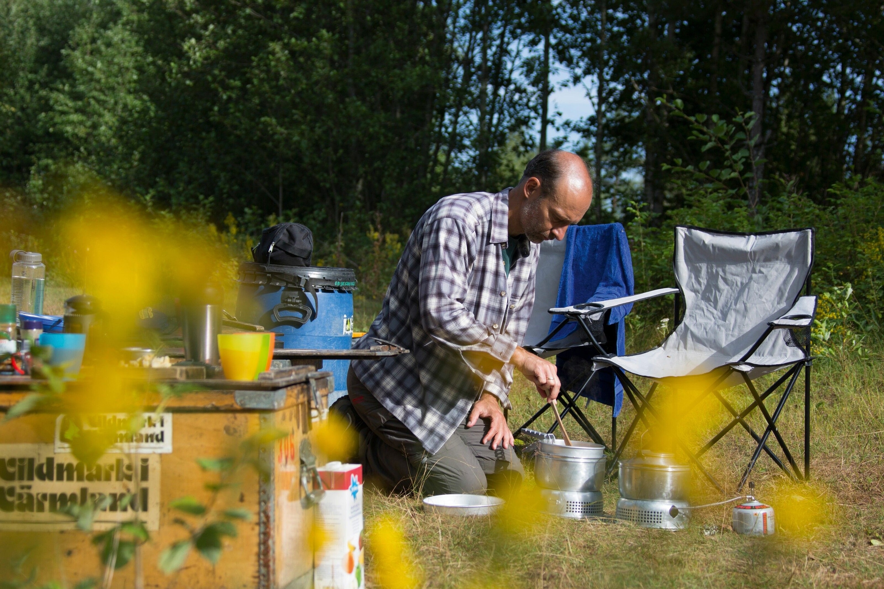 Cooking at a campsite, part of a log rafting trip, Sweden.